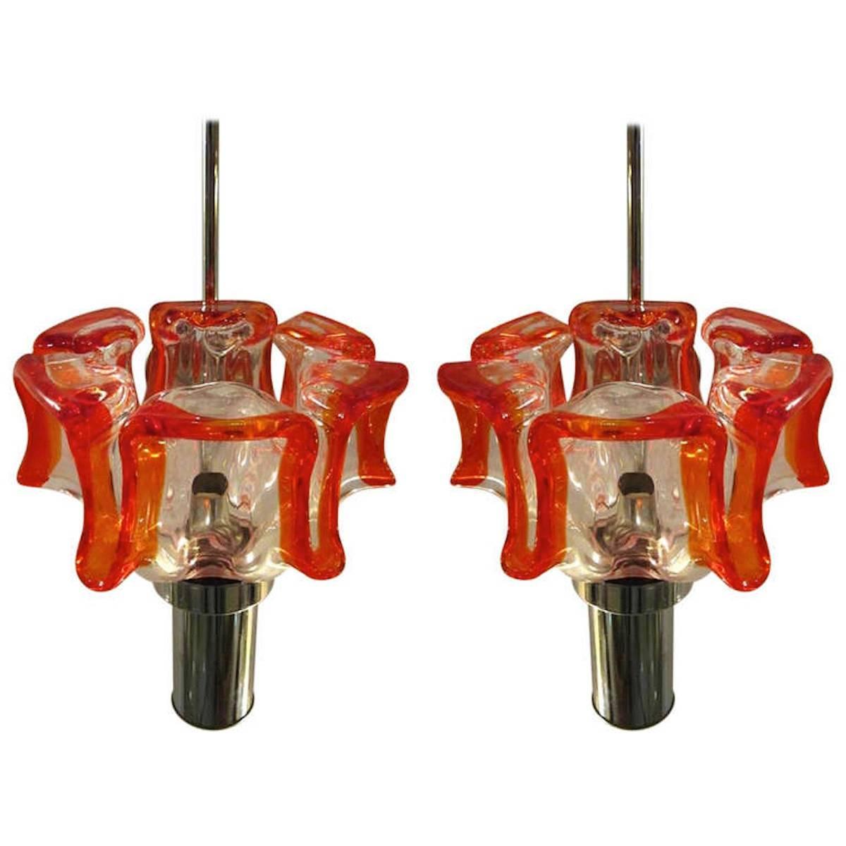 Pair of vintage Italian Murano glass sconces featuring stylized tulip shaped glass shades with a tangerine orange banding and chrome hardware.