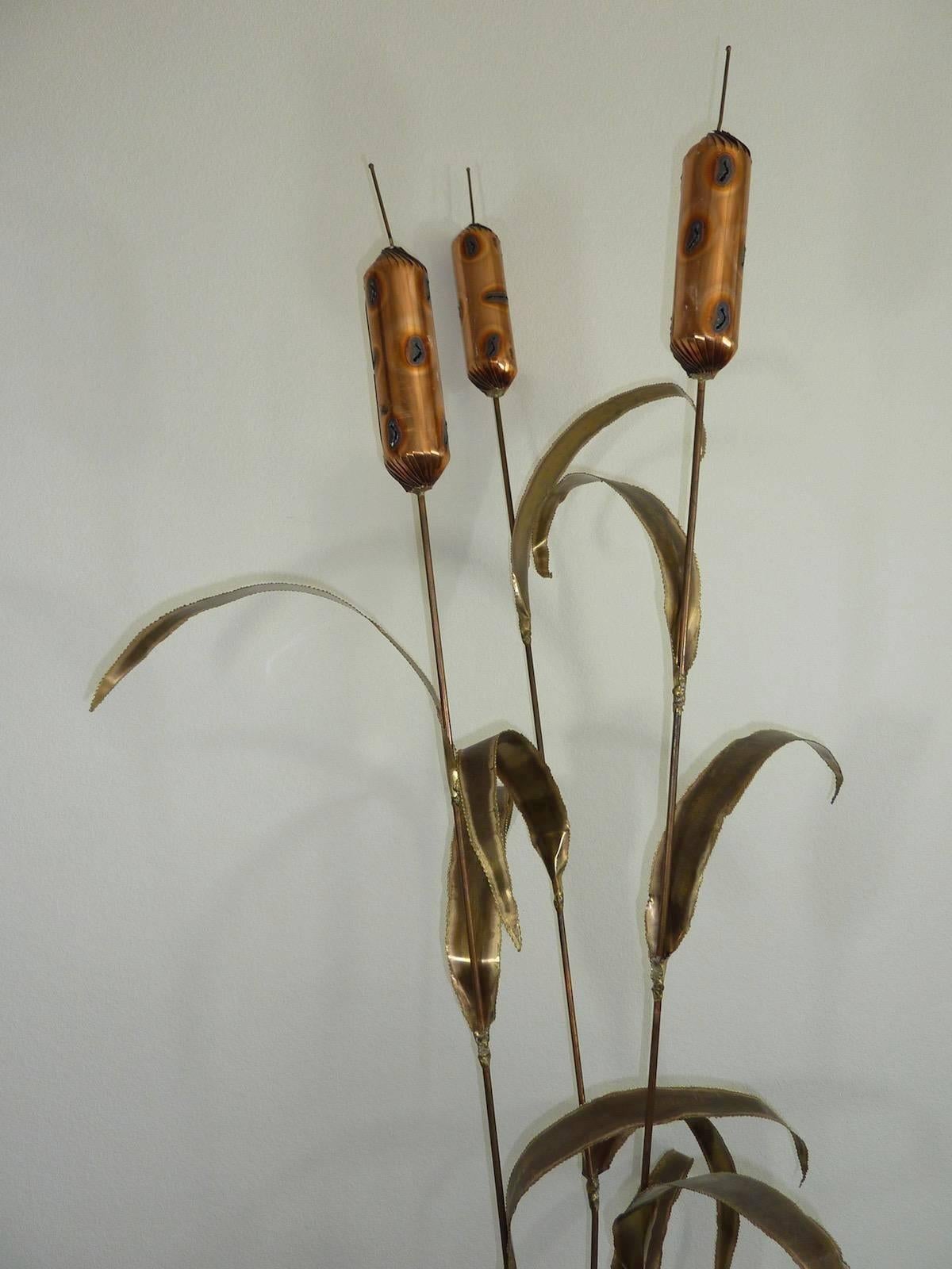 A brass floor sculpture in the form of cattails. Nice original old patina. Made in the 1970s. Brutalist style, made of copper, brass, and some other metals. It captures the eye when you enter a room. Great decorative item for office or home.