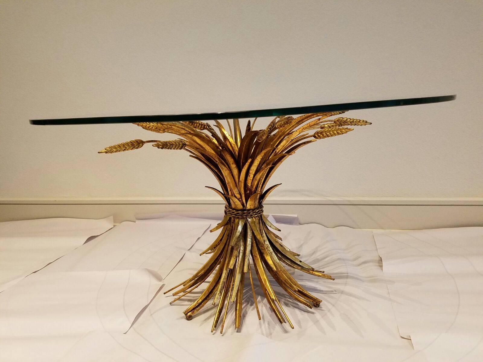 Offered is a 1960s era Hollywood Regency-style gilt wheat sheaf accent table with glass top. Made in Italy.