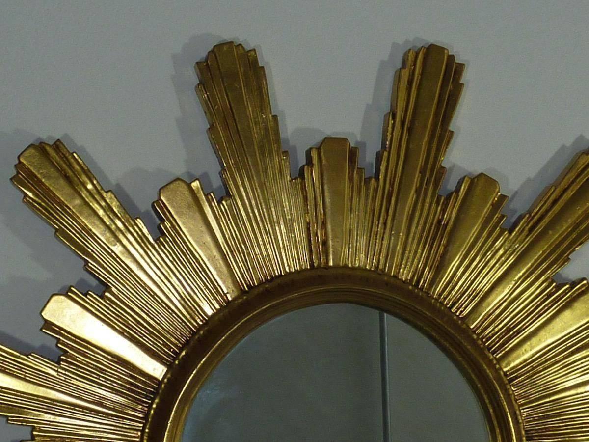 French Sunburst Starburst mirror made of resin plastic. Gilded with nice 20k gold paint. Glass is 14 1/2