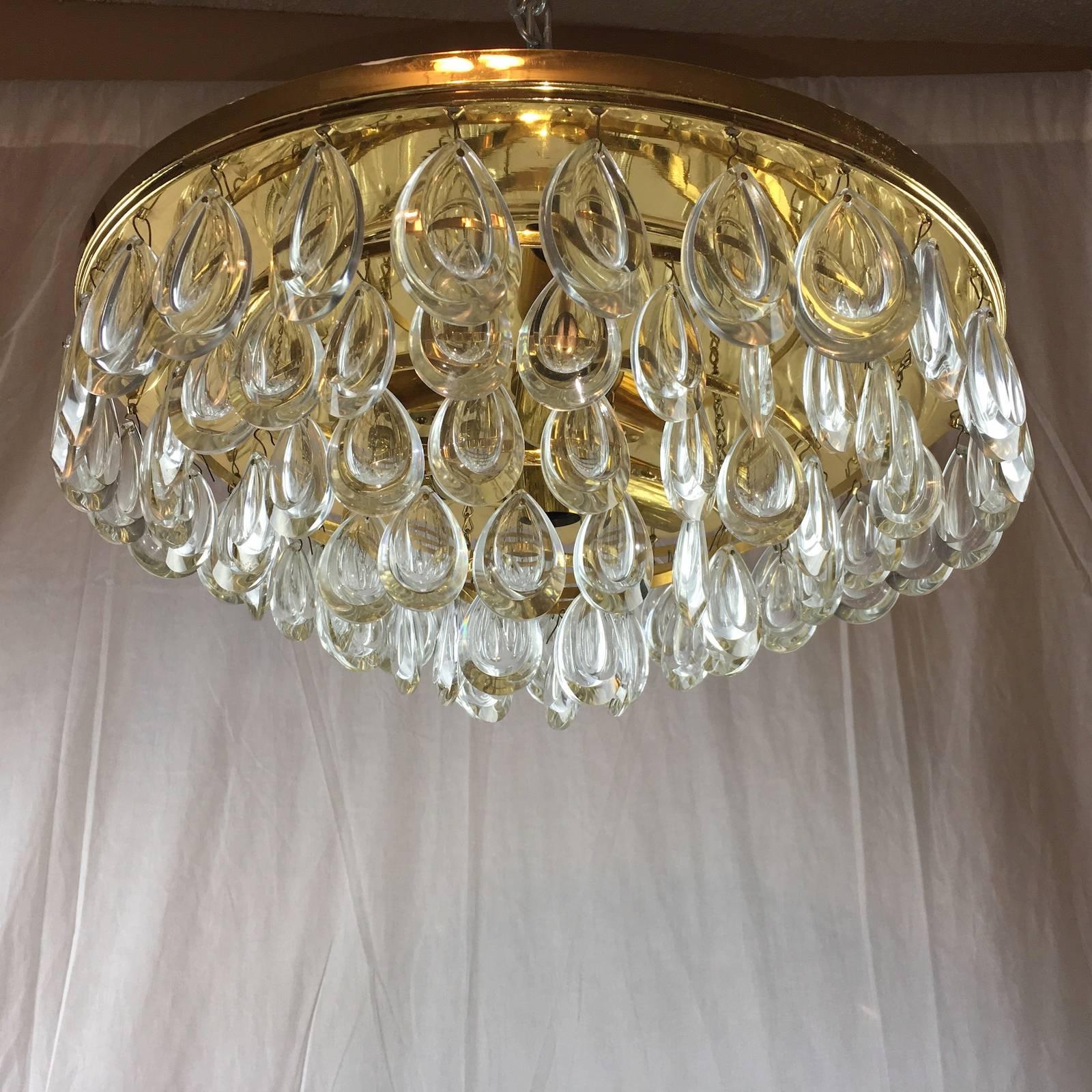 Beautiful flush mount made by Palwa in Germany, 1970s.
A gilt brass frame with five rows of teardrop-shaped glass in very nice original condition. The flush mount requires four European E14 candelabra bulb, each bulb up to 40 watts. One facing