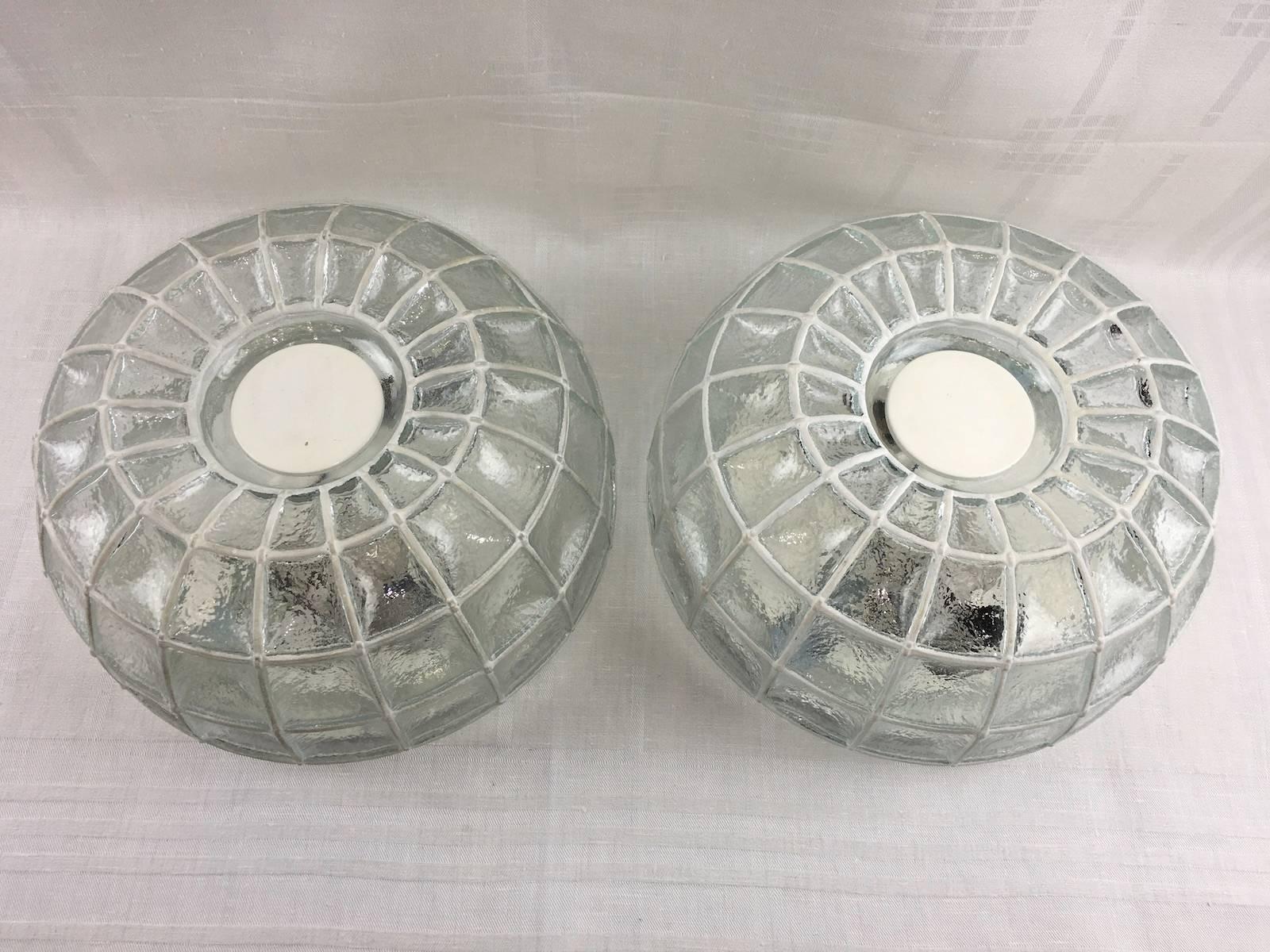 Pair of beautiful glass honeycomb ceiling fixture by Limburg, Germany. This light features a thick clear glass with white grid elements.
Takes two E27 base bulbs up to 60 wats per bulb.