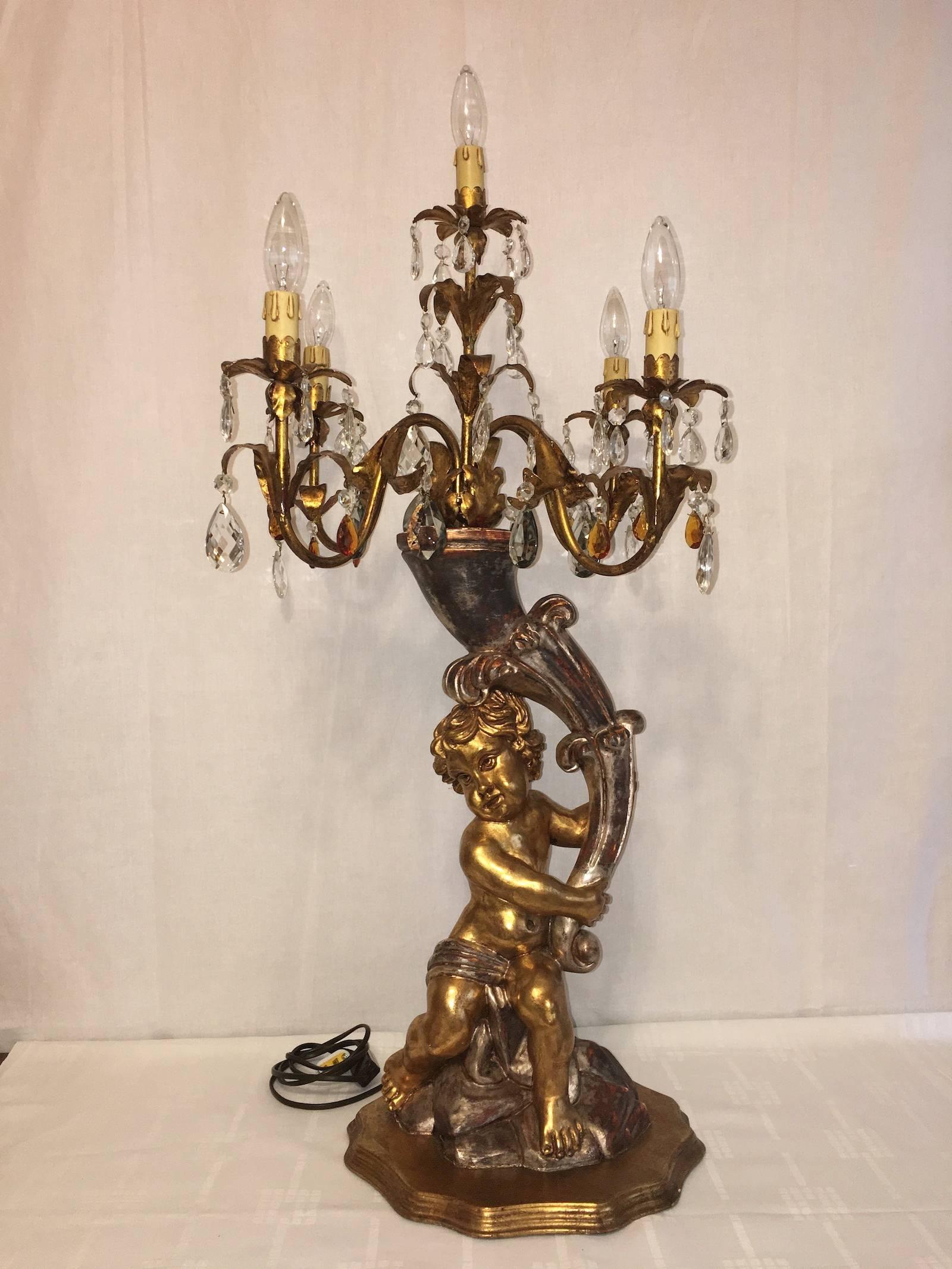 Beautiful wooden, crystal prism and gilded metal, large cherub figure table lamp. Can be used with E 14 candelabra bulbs or converters. Measure: It is approximate 20