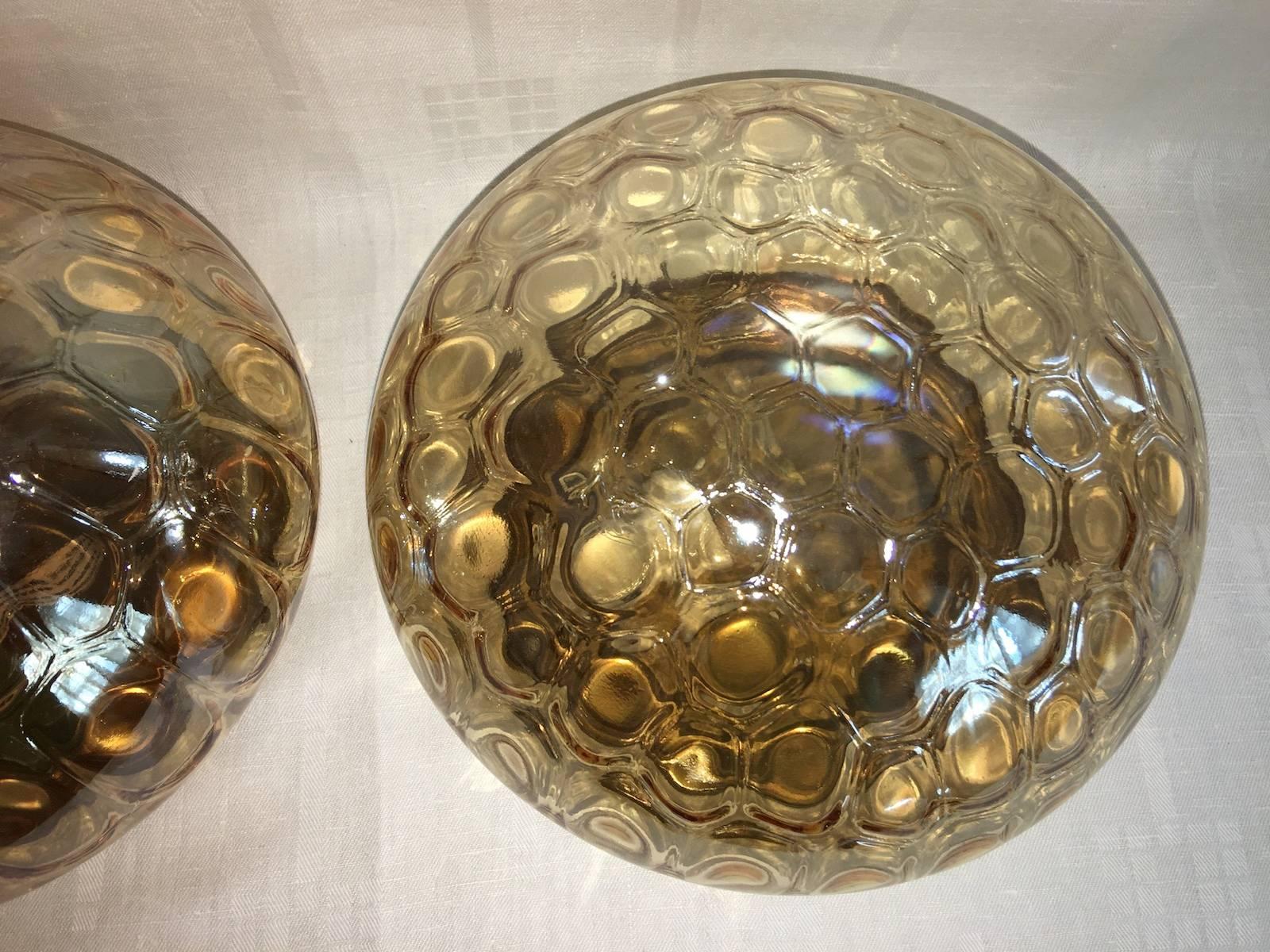 Pair of circa 1960s, German tortoise shell amber glass flush mount or sconces. Each Fixture requires one European E27 Edison bulb, each bulb up to 60 watts.