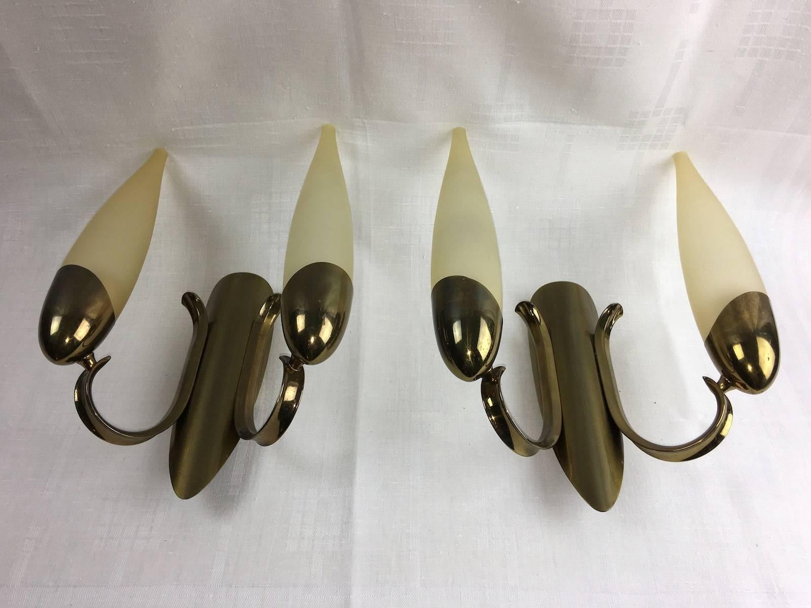 Pair of circa 1960s Italy glass and brass two tubes sconces with interior lights. Each fixture requires two European E14 candelabra bulbs, each bulb up to 40 watts.