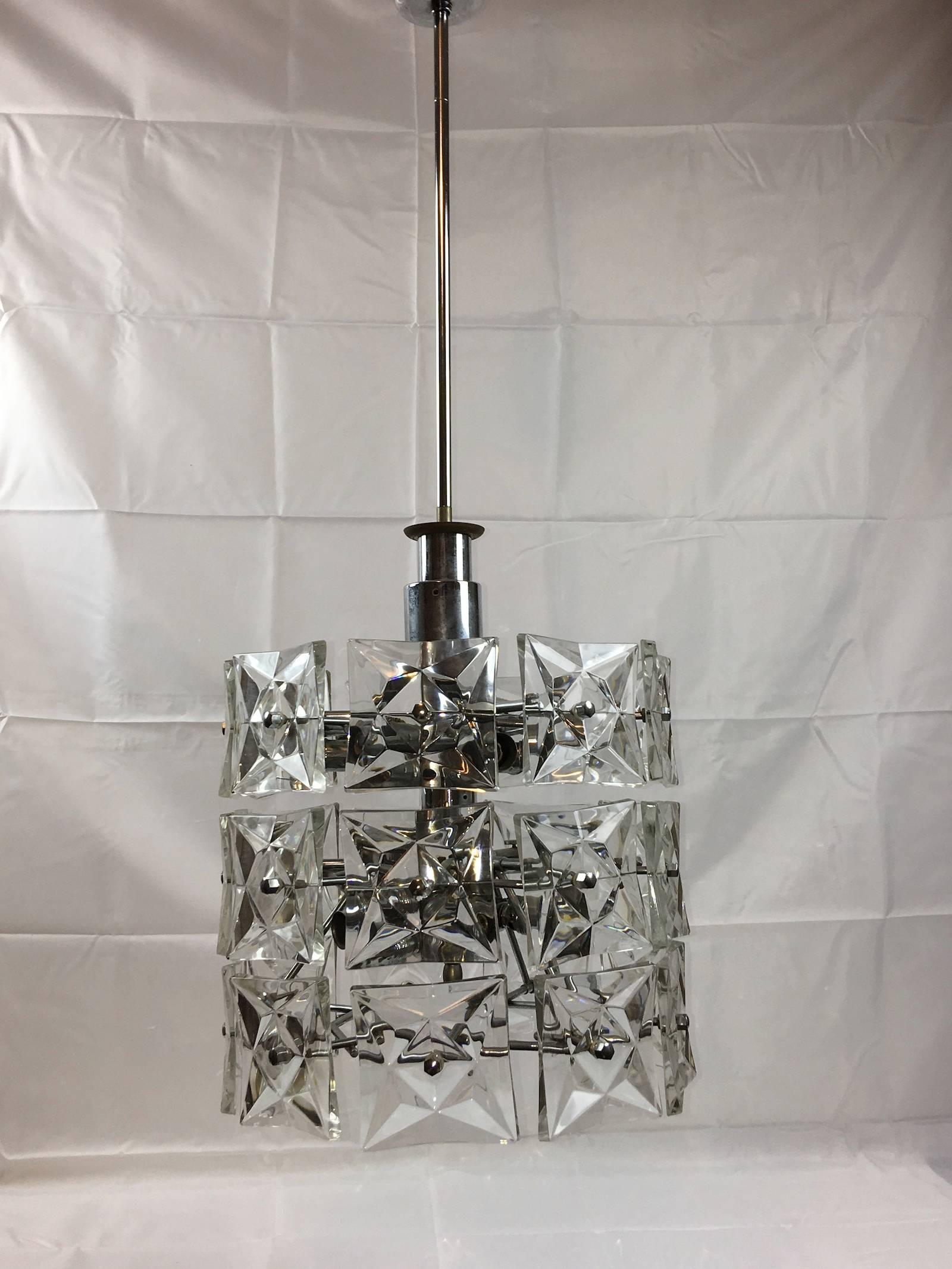 German 1970s Kinkeldey geometric three rows crystal fixtures with chrome hardware with interior lights. The fixture requires twelve European E 14 candelabra bulbs, each bulb up to 40 watts.
A very unique looking item.