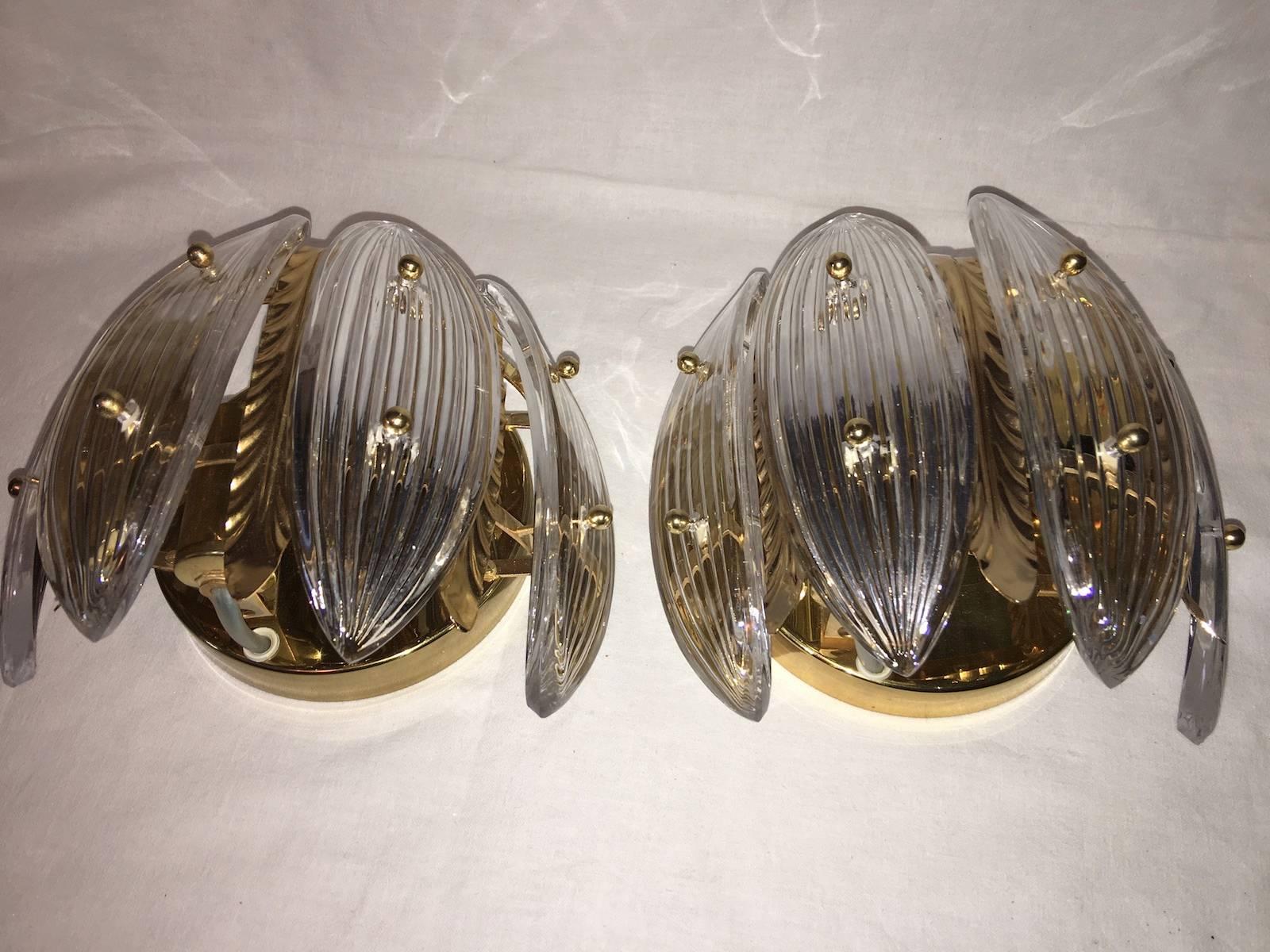 Pair of wall sconces in gold-plated metal and glass. The glasses look like Palm Leafs. Palwa No. 7760. Each Fixture requires two European E14 candelabra bulbs, each bulb up to 40 watts.