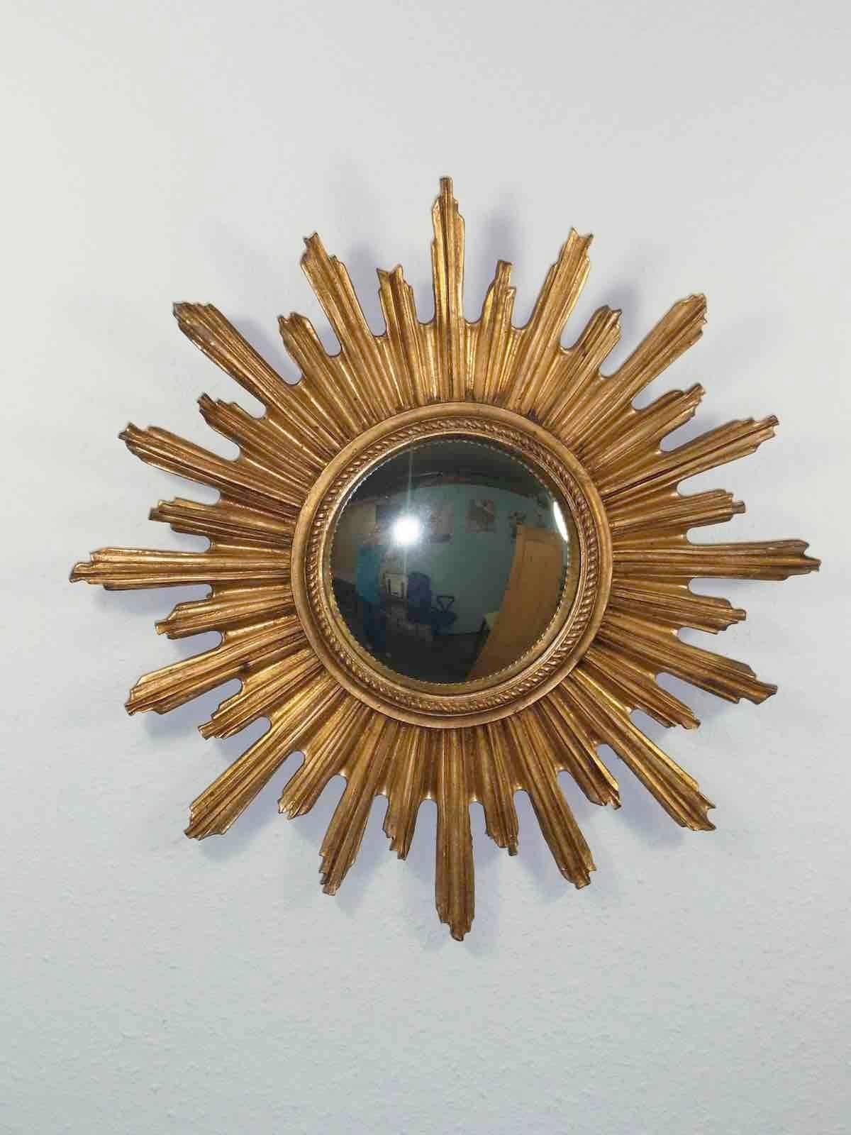 Gorgeous starburst mirror. 
Made of gilded Resin.
No chips, no cracks, no repairs.
It measures approximate 21 1/4"; in diameter,
Mirror only is approximate 7 1/4"; in diameter.
It stands approximate 1 3/4"; from the wall to the