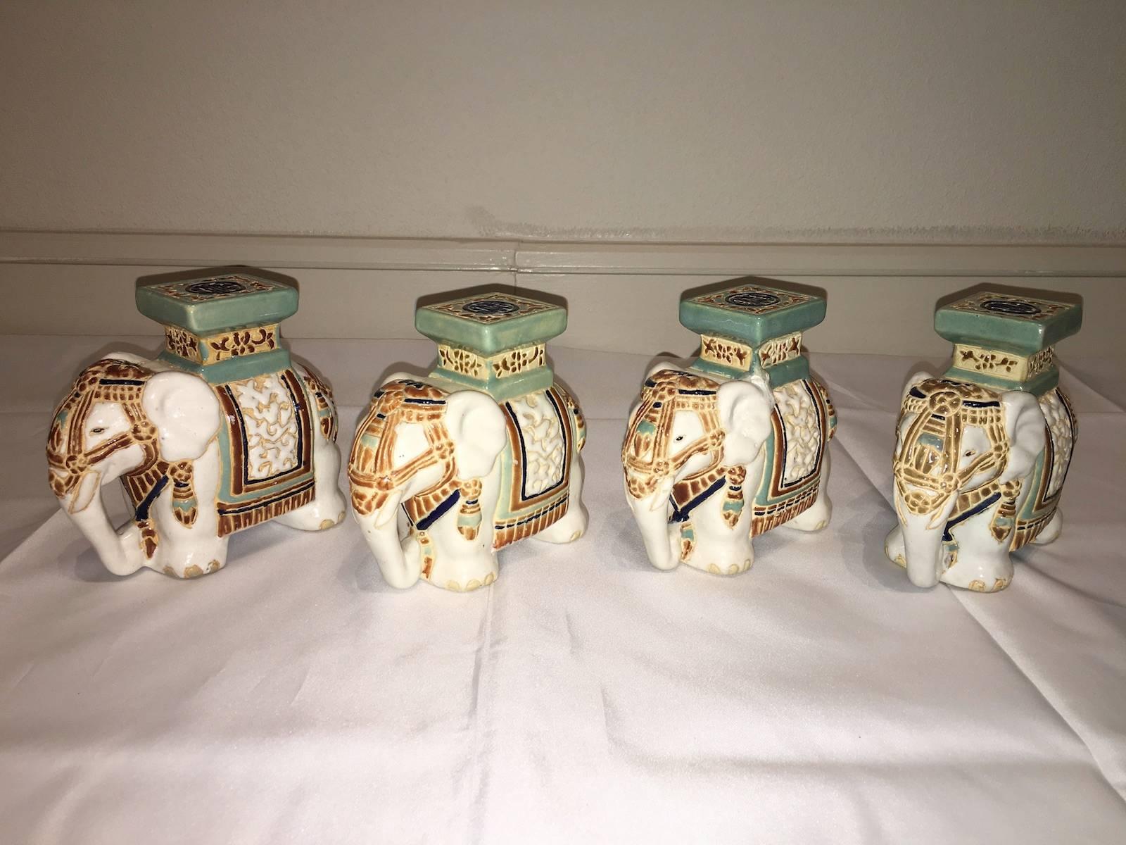 Lot of four petite Mid-20th century glazed ceramic elephant bookends, plant stands, flower pot stand. Handmade of ceramic. Nice addition to your home, patio or garden.
