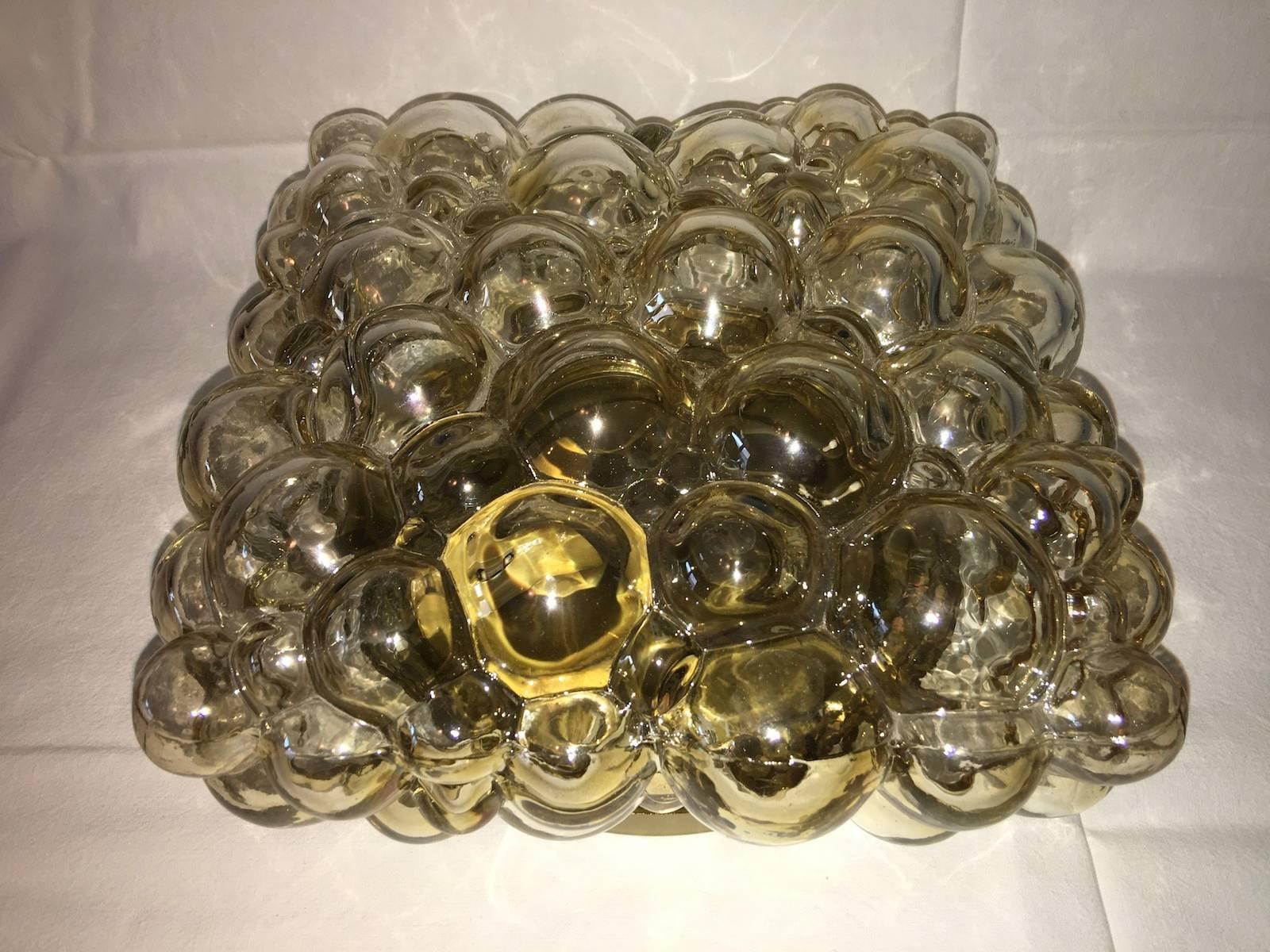 A stunning, vintage German made bubble glass flush mount wall light or sconce designed by Helena Tynell for Glashütte Limburg in the early 1960s. Featuring beautiful Amber/ Champagne colored/ coloured glass it warms up any heart, mind or room. The