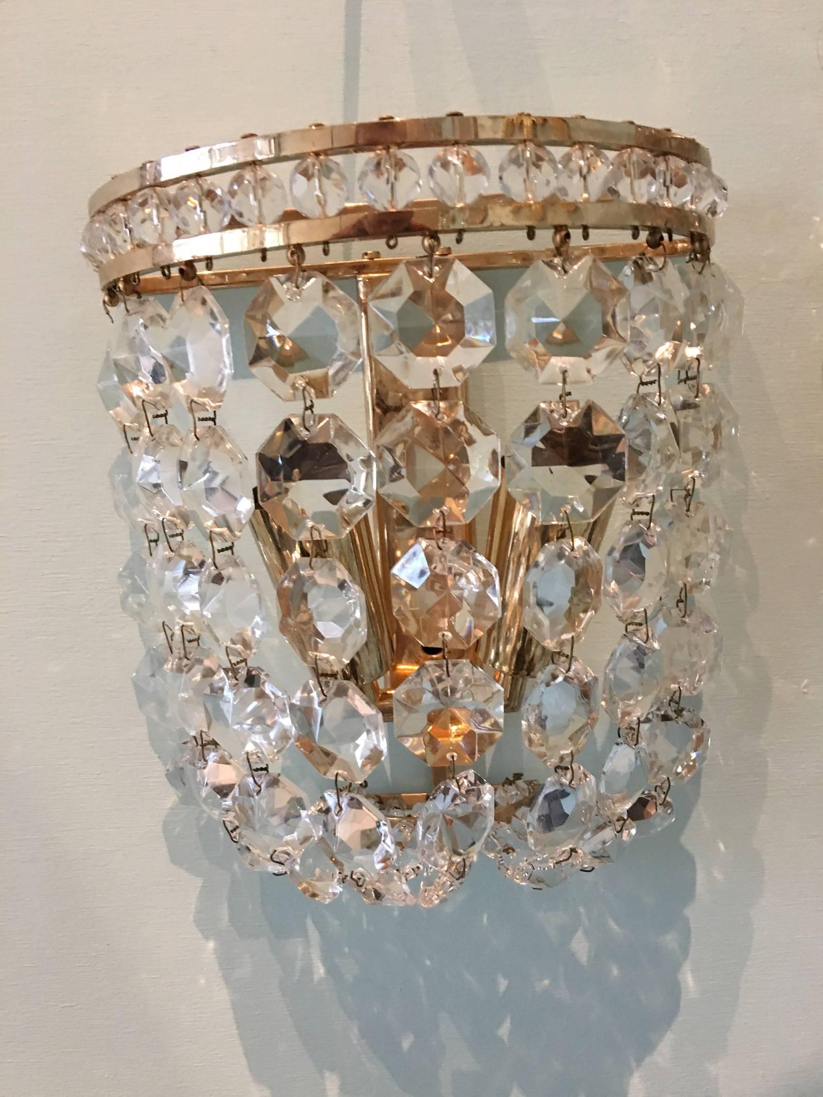 A pair sconces crystal elements on brass armature. The fixture requires two European E 14 candelabra bulbs, each bulb up to 40 watts.