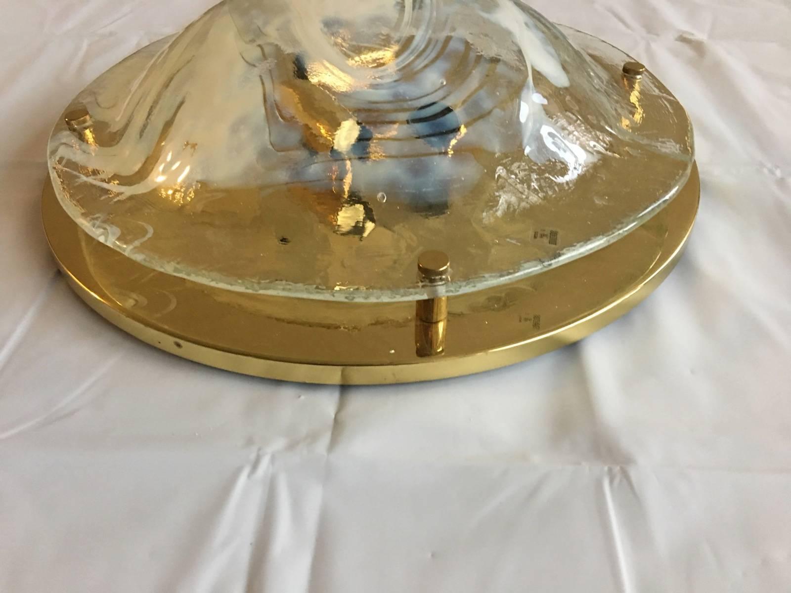 A beautiful Mid-Century Italian round Murano glass flush mount  with brass hardware for interior lights.
The fixture requires three European E 14 candelabra bulbs, each bulb up to 60 watts.
Unique and beautiful item