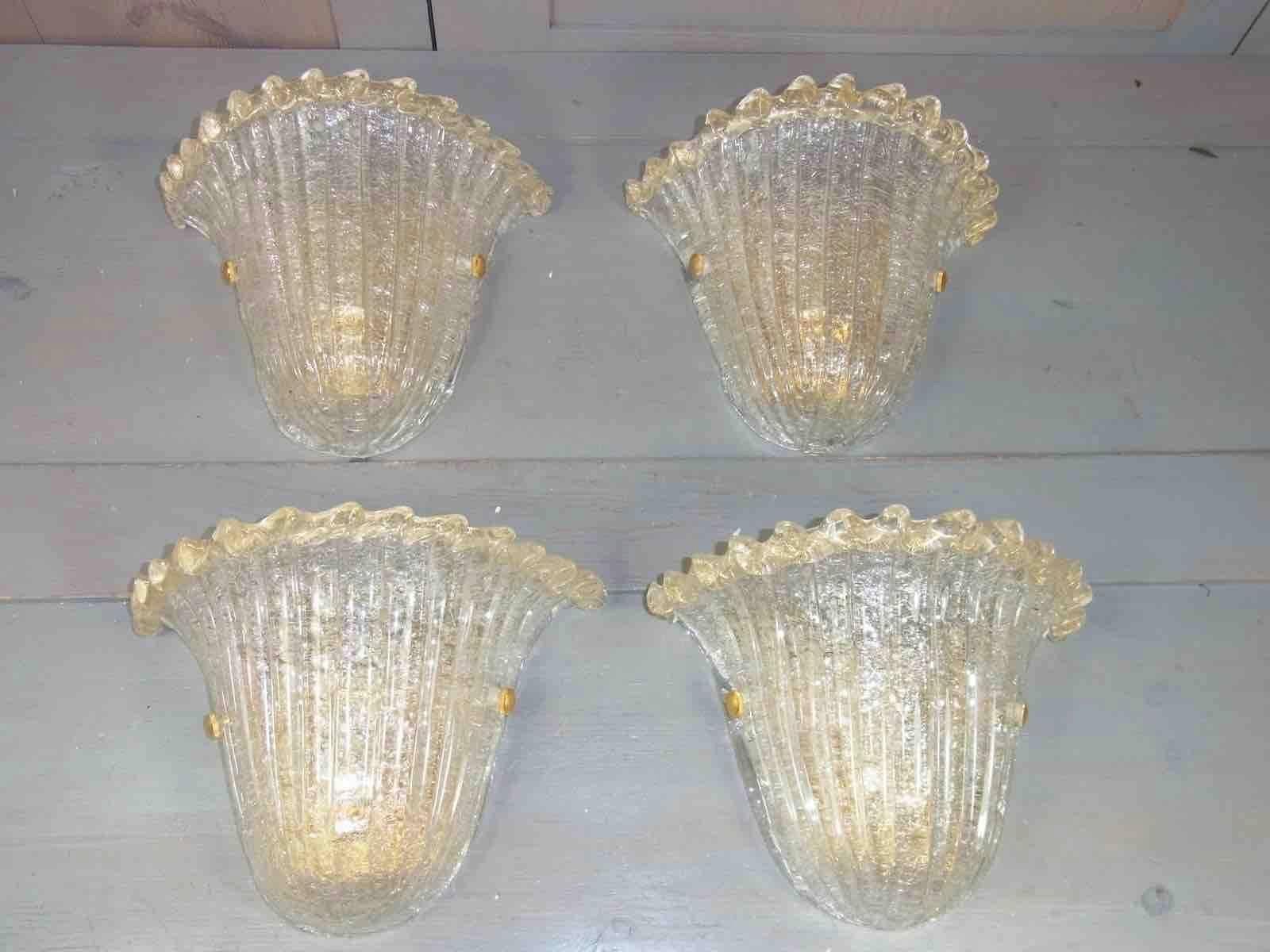 Two pair of beautiful Murano glass shell sconces. Made of heavy Murano glass and gold-plated metal. Each fixture requires one European E27 Edison bulb, each bulb up to 60 watts.