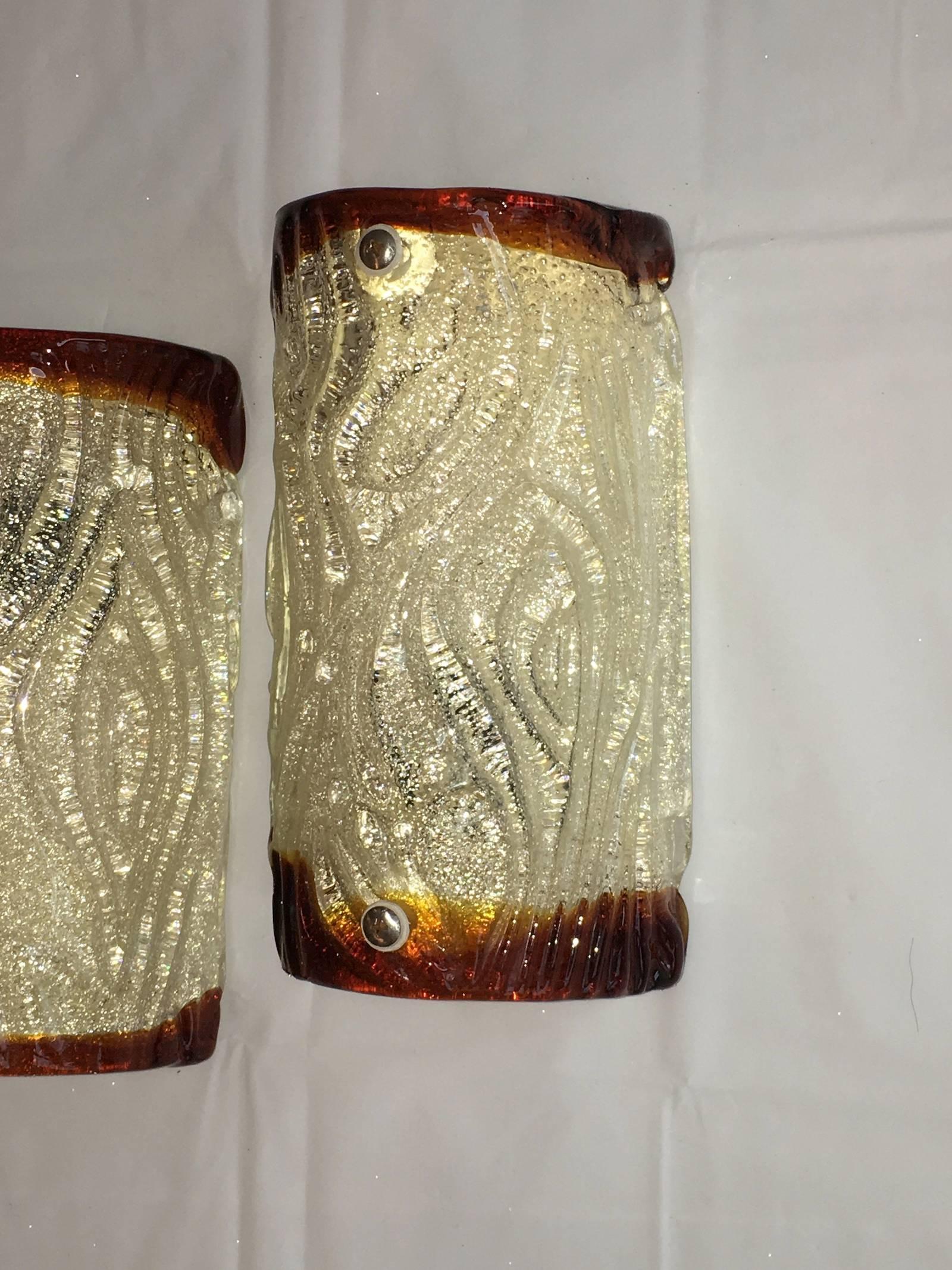 A pair of Murano sconces in the style of Mazzega with thick Murano textured glass.
Each fixture requires one European E14 candelabra bulb, each bulb up to 60 watts.