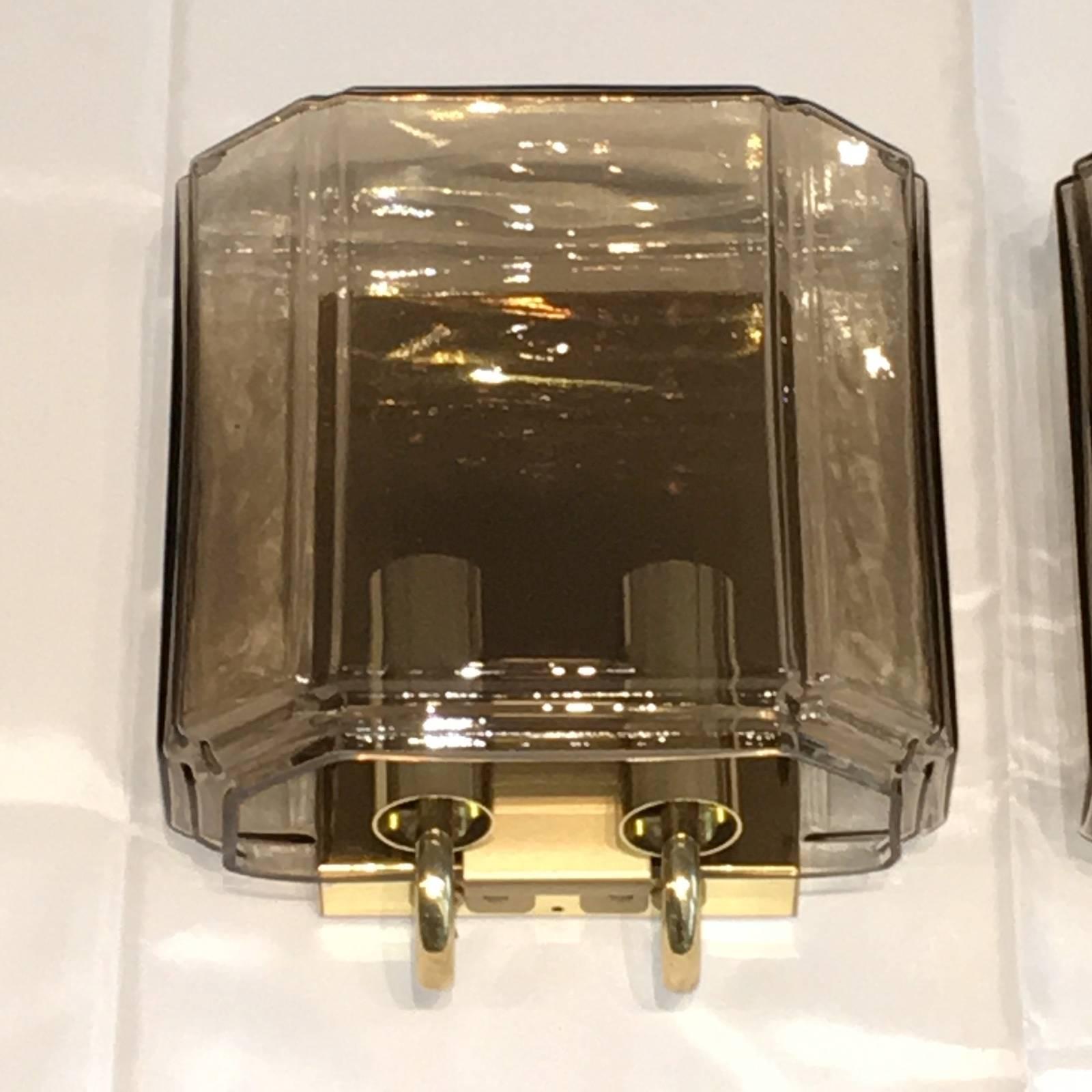 A pair of sconces by Glashuette Limburg, Germany. Gorgeous amber glass sconces with metal fixture. Great size and stunning design. Brings a touch of elegance to the room. Each fixture requires two European E 14 candelabra bulb up to 40 watts.
 