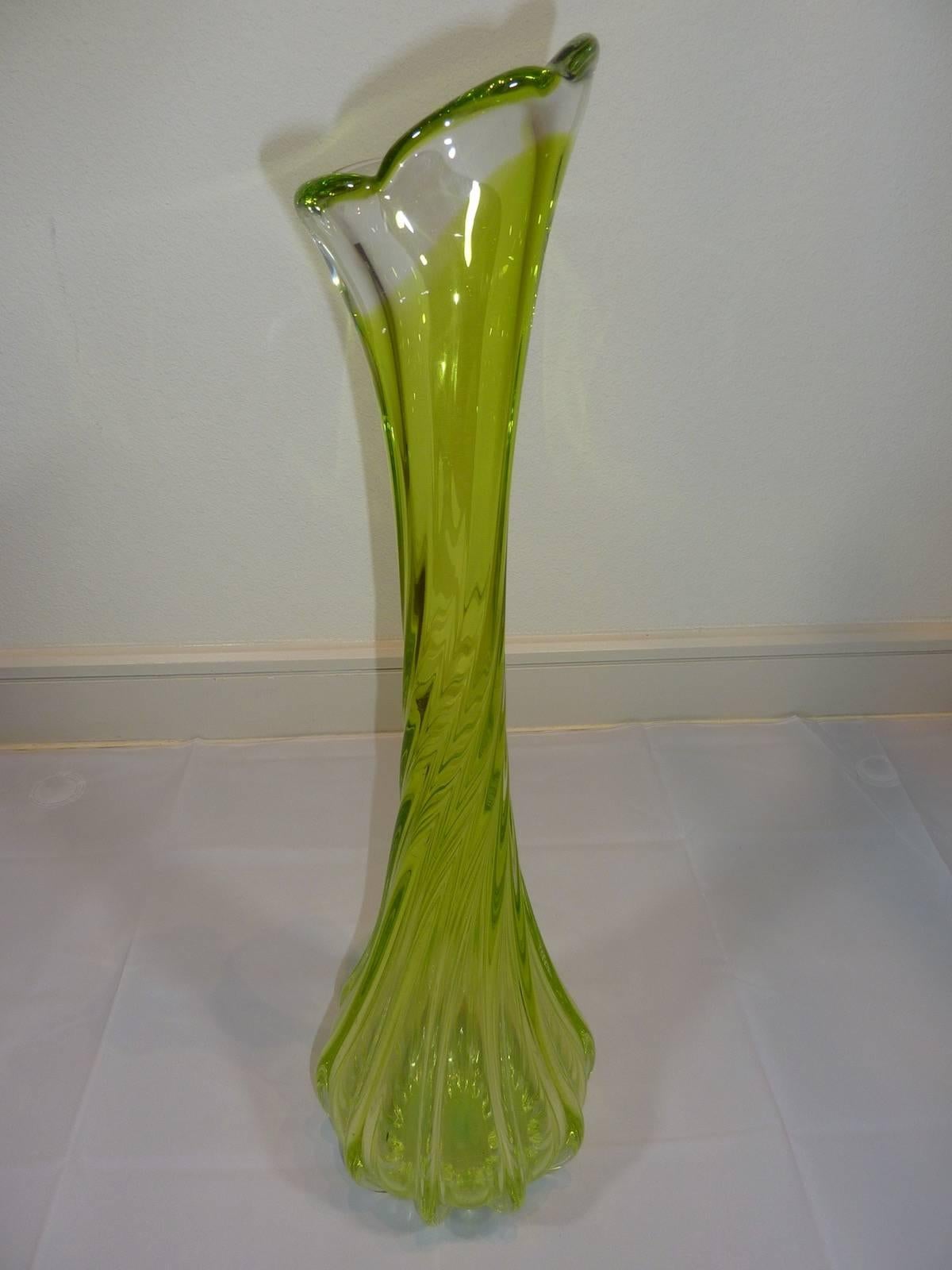 Beautiful Italian vase, dating circa 1960s. The lime green and clear glass swirls down to the ground. Made in Murano, Italy.