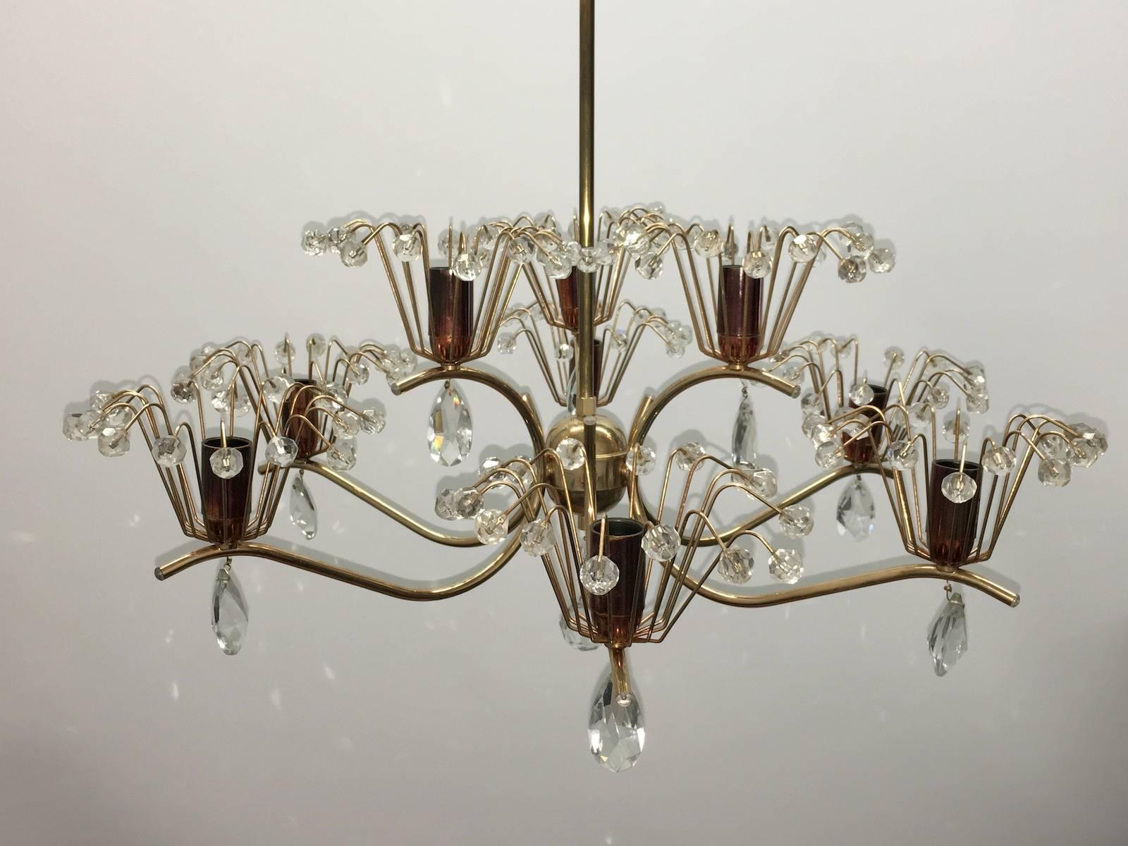 A beautiful chandelier in the form of a fountain. Attributed to Emil Stejnar for Rupert Nikoll, Vienna, Austria. An original vintage piece manufactured in Mid-Century (1950s-1960s). It is made of brass, copper and hand-cut crystals. It requires nine