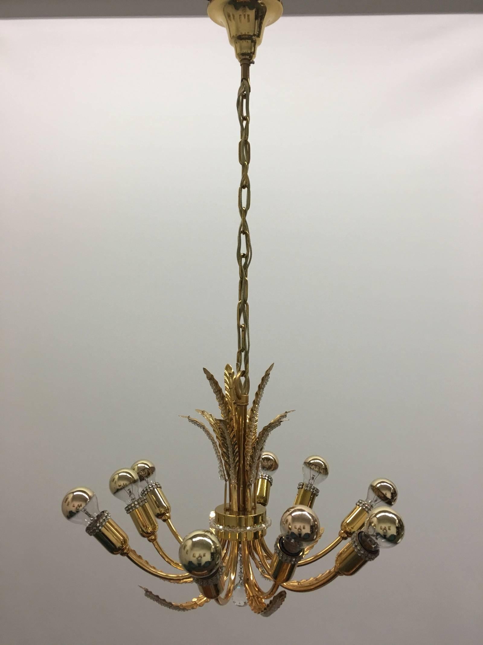 An absolutely stunning Mid-Century German gilt brass and cut crystal chandelier by Palwa, circa 1970s. Perfect for the Hollywood Regency style, there is no better combination than gold and crystal for the opulent, decadent and luxurious look of the