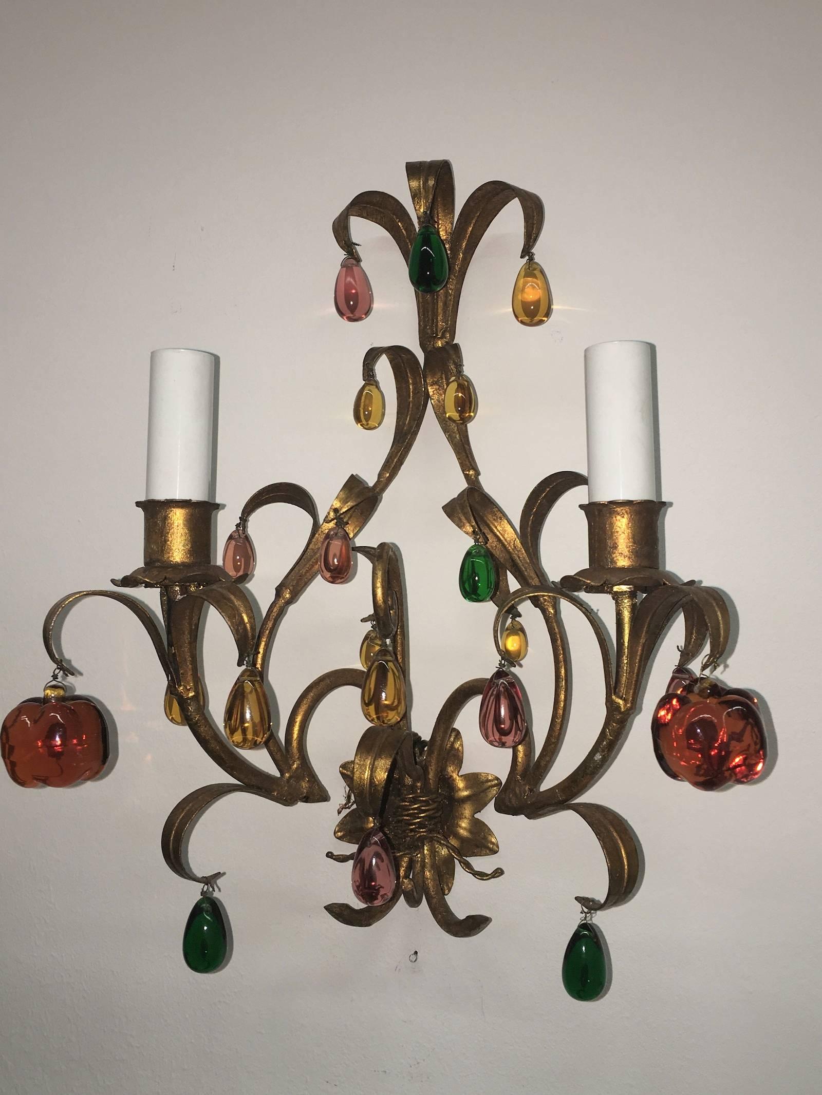 A beautiful pair of Florentine style wall light sconces, made in Italy in the 1960s. Hand-painted metal bases with Murano glass drops and fruits. Each fixture requires two European E14 candelabra bulbs, each bulb up to 40 watts.