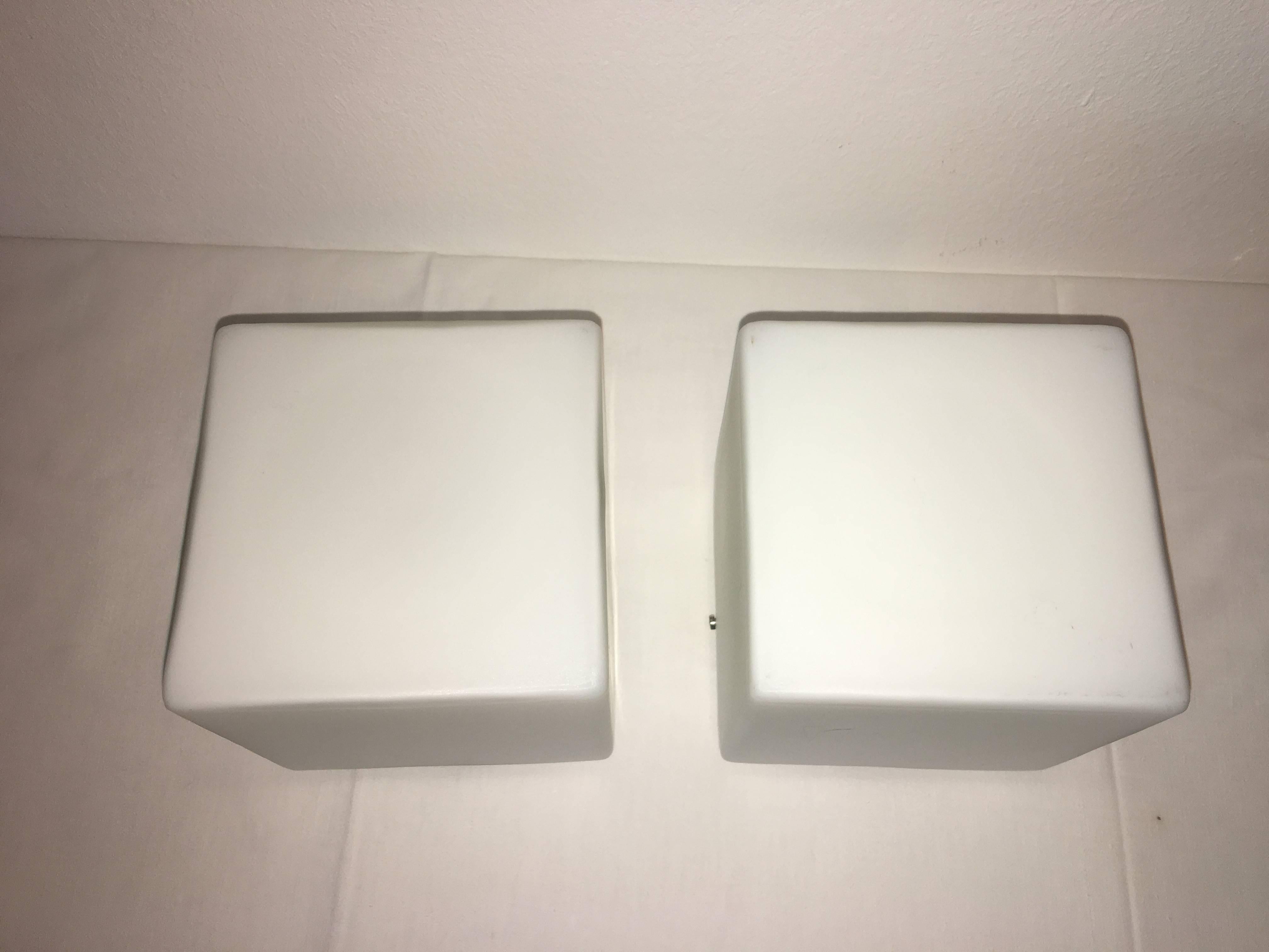 A set of two milk glass cube flush mount in style of Stilnovo, 1960s, Italy. Each fixture requires one European E14 candelabra bulb, up to 40 watts. Sleek modern yet vintage look !