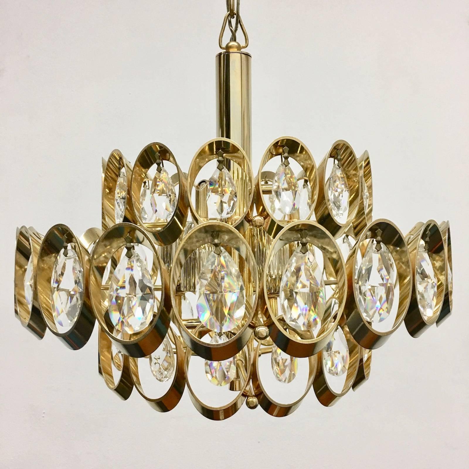 Beautiful crystal chandelier by Palwa Leuchten. This beautiful piece in the Hollywood Regency style is a nice addition to every home. The fixture requires six European E14 candelabra bulbs, each bulb up to 40 watts.