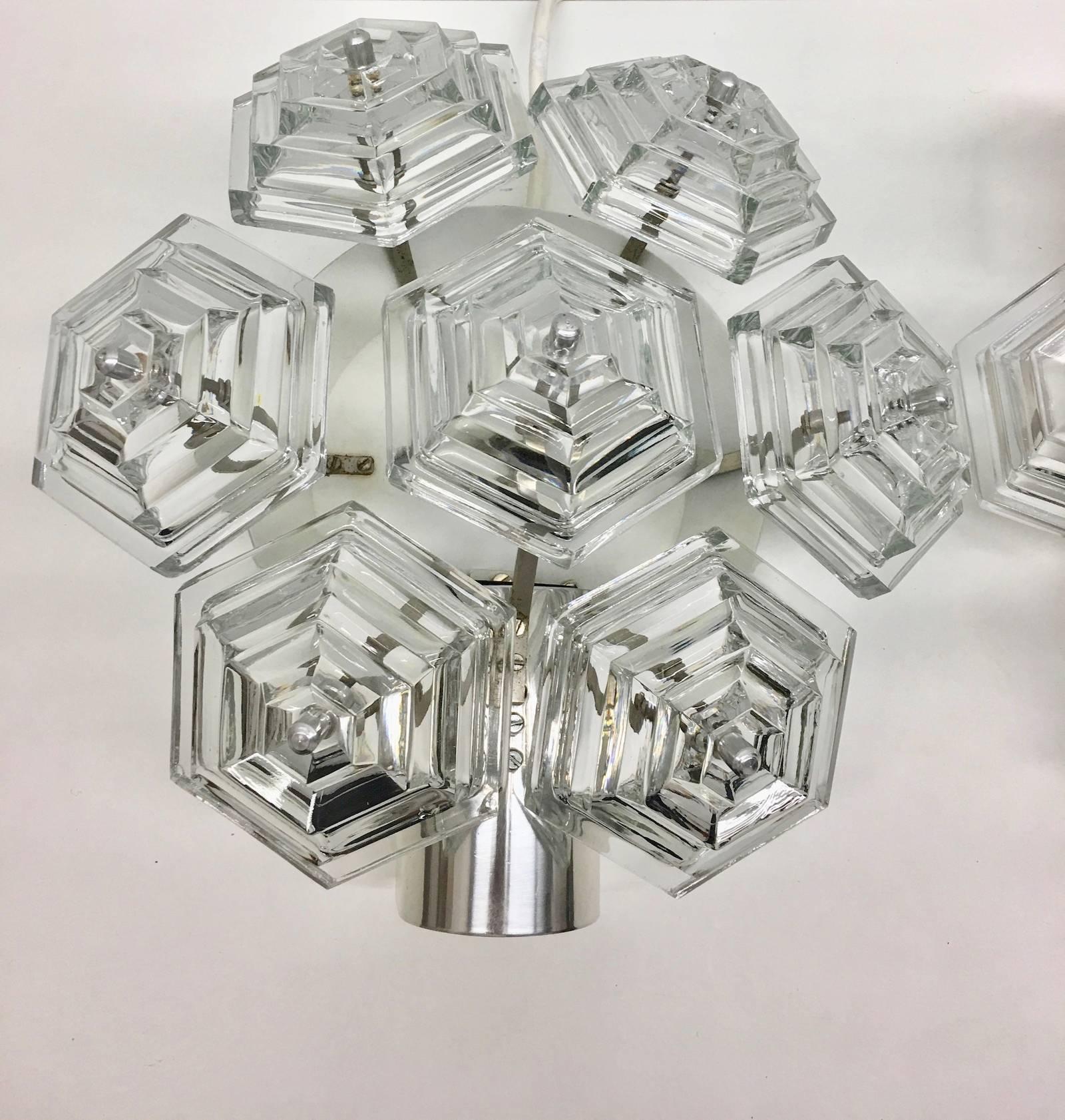 A beautiful pair of chrome and glass prism sconce. By VEB Kristall Leuchten in the GDR. Each fixture requires one European E27 Edison bulb, up to 60 watts.
Note: Due to the vintage nature of this fixtures, there may be some nicks or imperfections