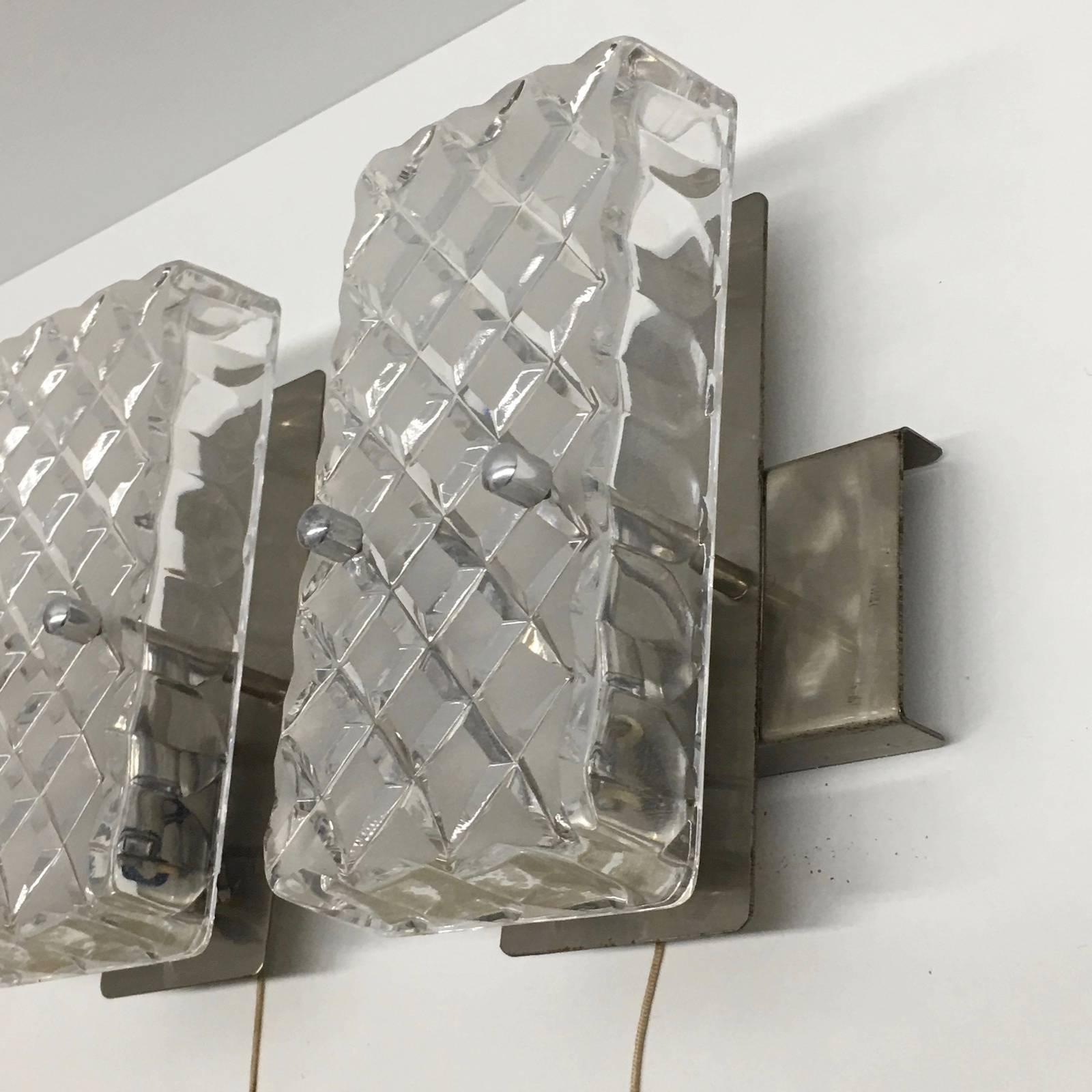 A pair of 1970s sconces from Germany. Constructed with rectangular glass. Each fixture requires one European E14 candelabra bulb, each bulb up to 60 watts. Great look great lighting effect.
