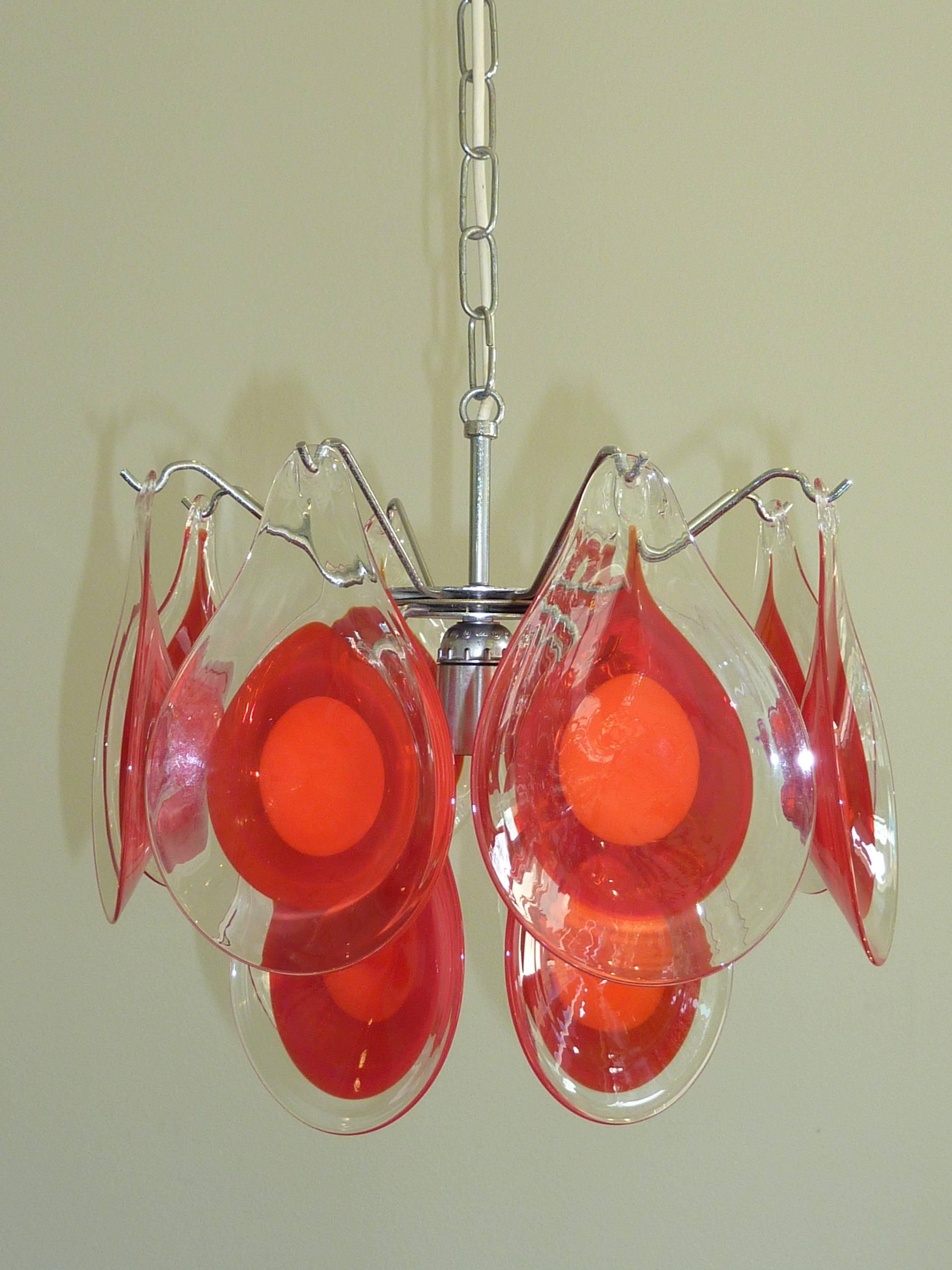Beautiful and rare petit chandelier with 12 red and clear glass tear drop shaped art glasses. The fixture retains original European wiring. It requires E26 medium base light bulb. The chain with canopy is approximately 22 inches long. Priced to sell