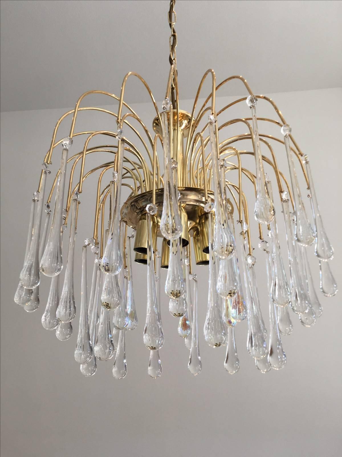 Very elegant and great quality, vintage Mid-Century chandelier. This piece has a brass frame with clear Murano teardrop crystals. The chain with canopy is approx. Measures: 17" in length.