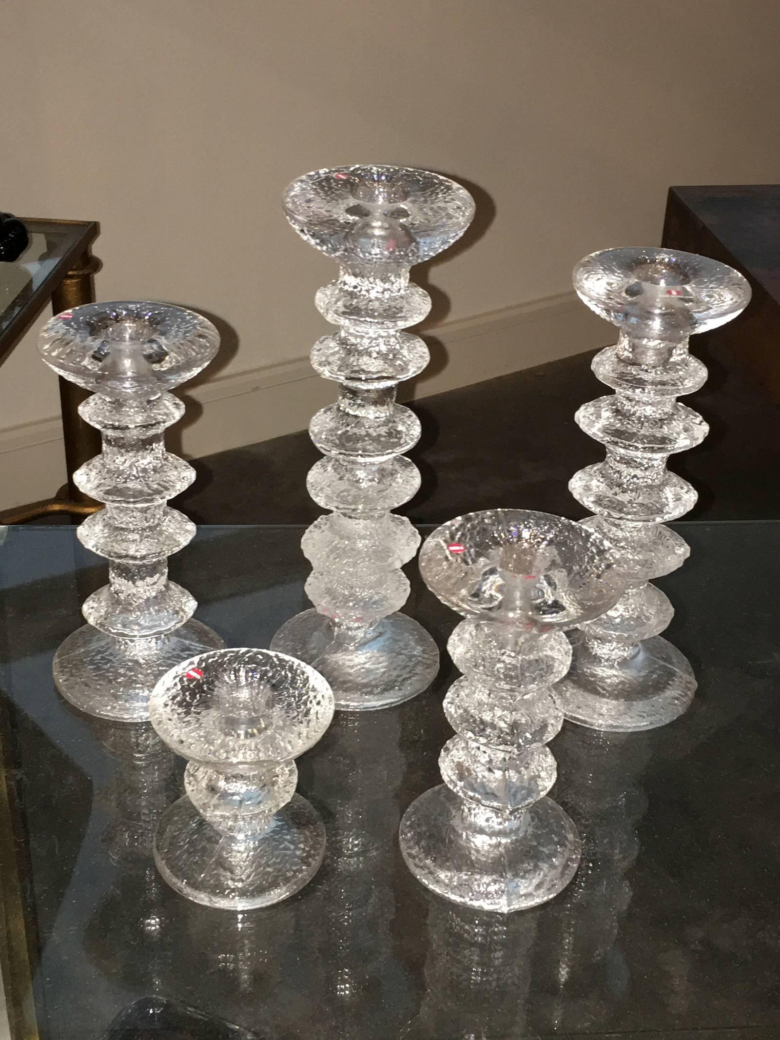 Five Kekkerit ice glass candle stick holder. Made in Finland by Timo Sarpaneva. Tallest is approximately 9 1/2 high, smallest 3 1/4 high.