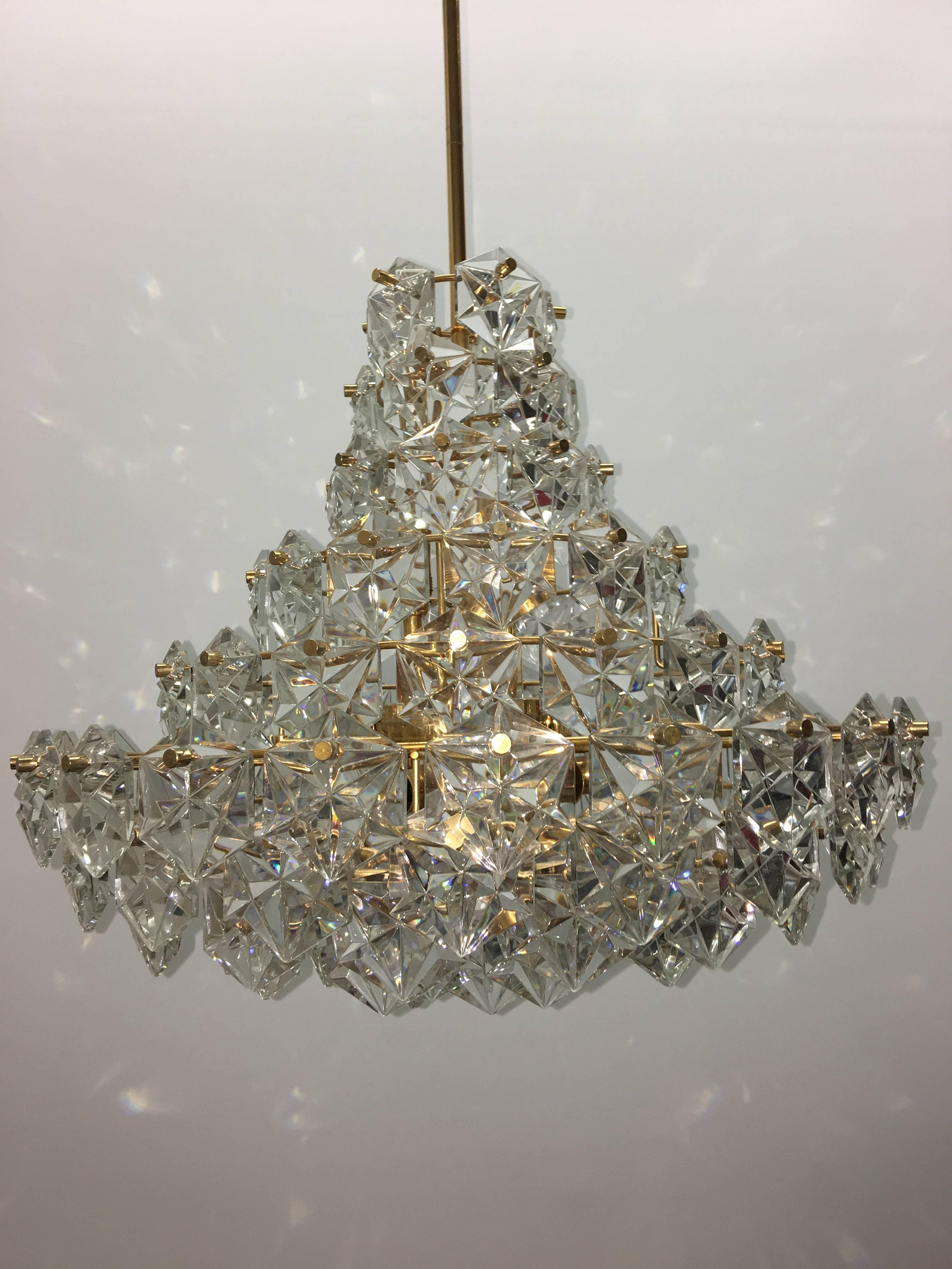 Faceted hexagonal crystal chandelier with gold colored hardware made by German maker, Kinkeldey. The chandelier requires nine European E14 candelabra bulbs, each bulb up to 40 watts. It also needs one E 27 Edison bulb up to 60 watts. Very warm in