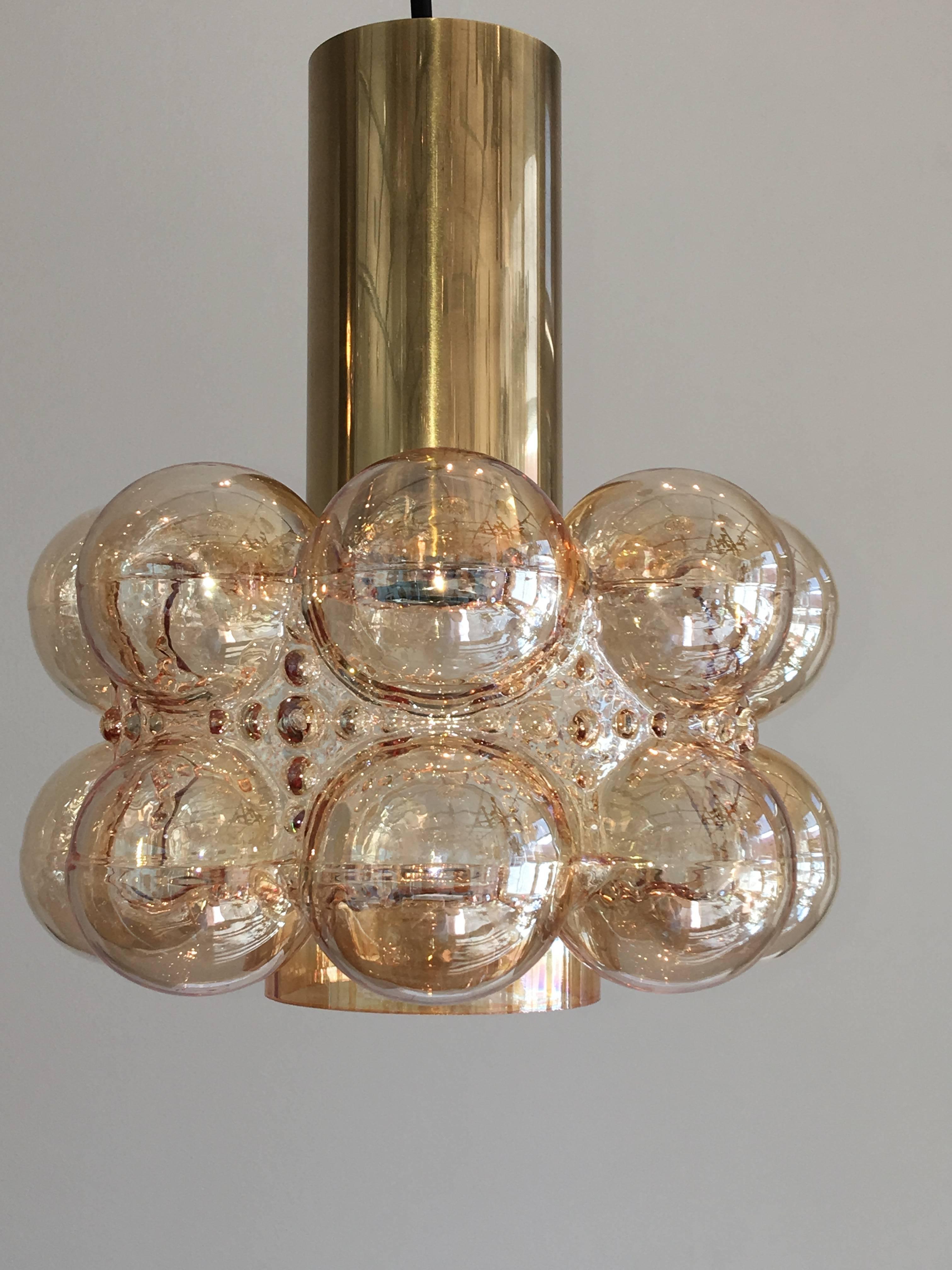 A beautiful German Limburg brass and bubble glass pendant by Helena Tynell. The fixture requires one European E27 Edison or medium bulb with up to 60 watts.