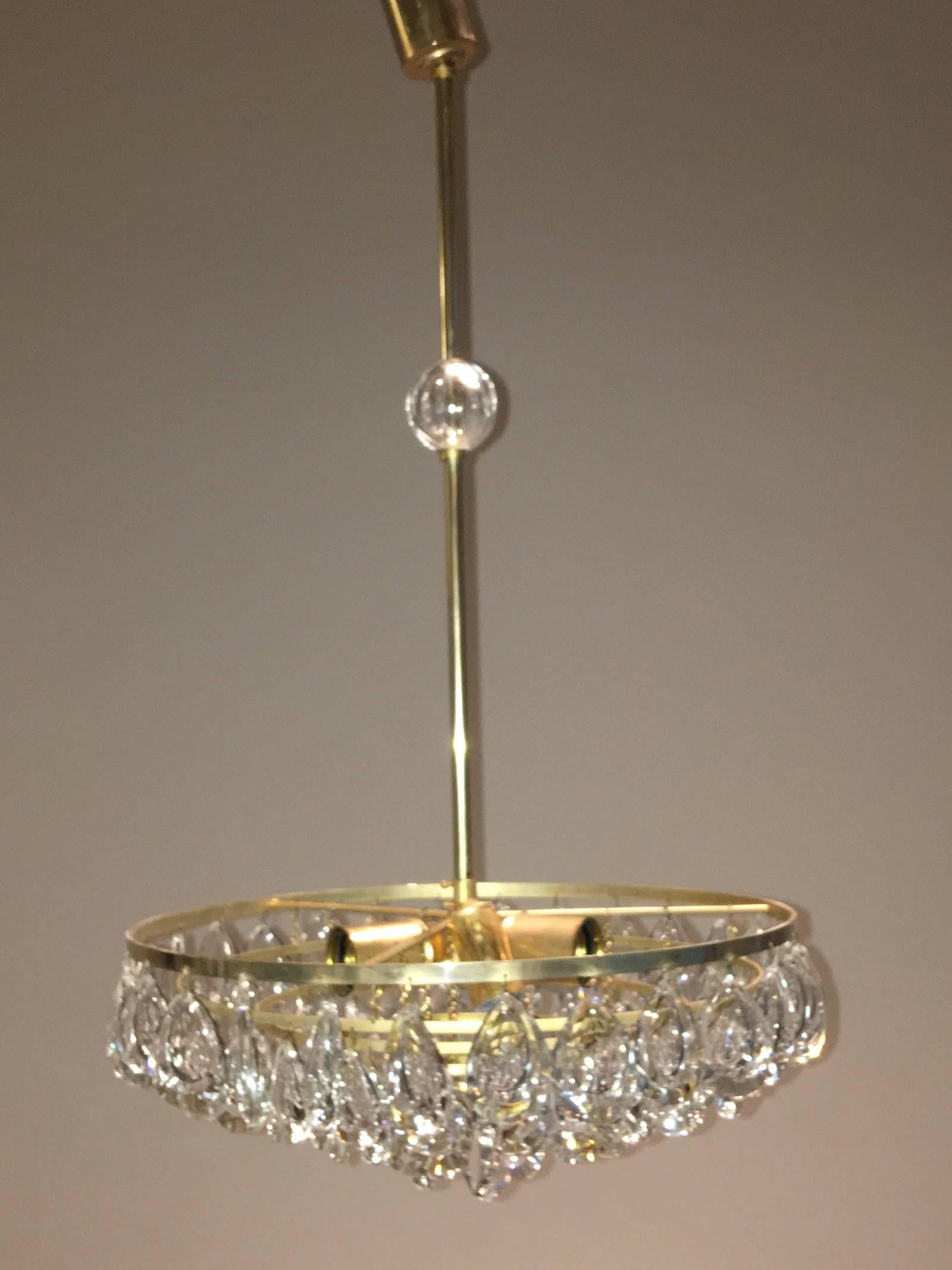 A German teardrop crystal glass chandelier by Palwa
The fixture requires three European E 27 Edison bulbs and one E 14 candelabra bulb, each bulb up to 40 watts.
Note: With minor signs of wear as expected with age and use, also slight wear to the