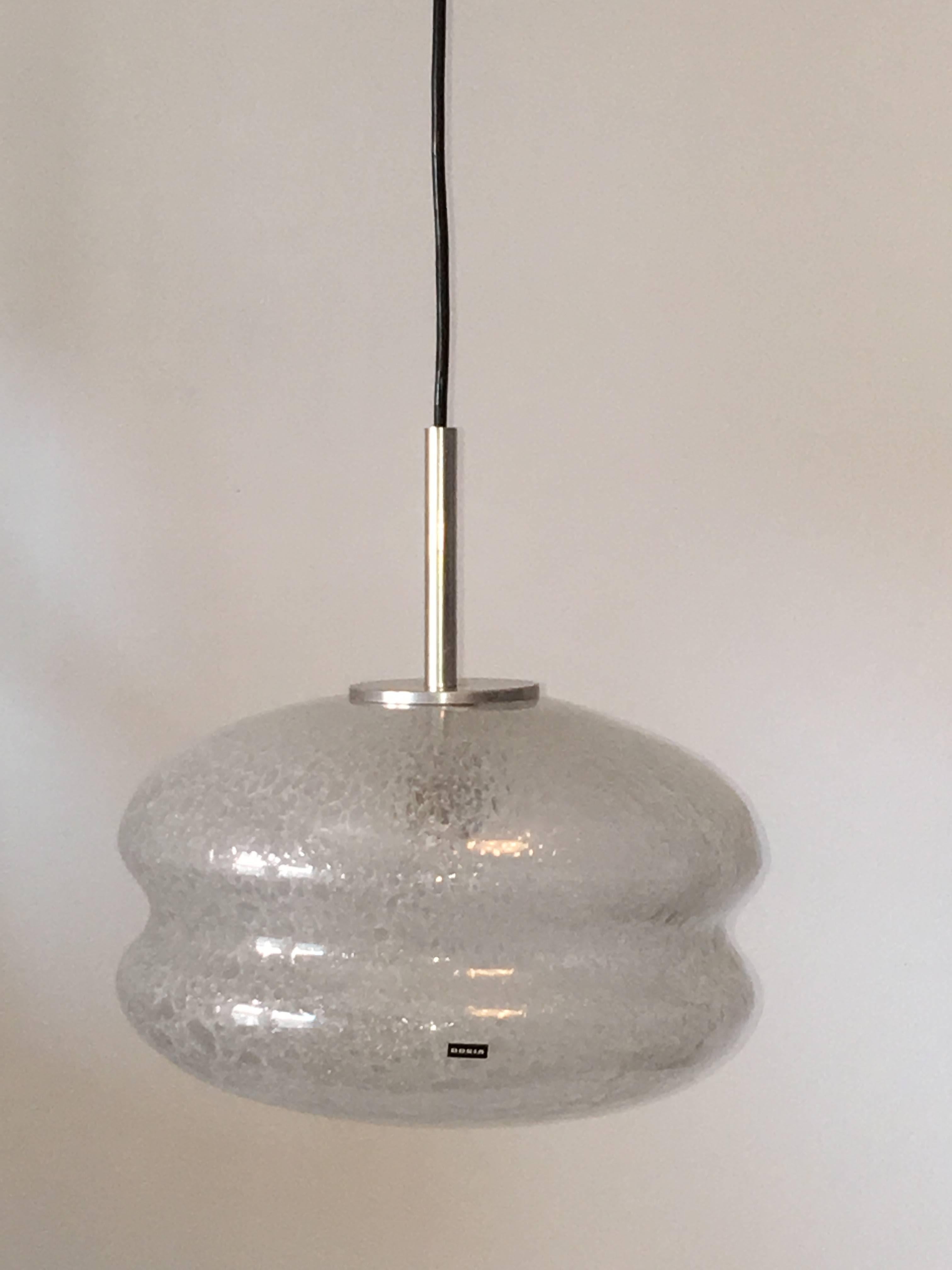 A air bubble glass pendant made in the 1960s by Doria, it has a black colored wire. The fixture requires one European E27 Edison bulb, up to 150 watts. Very nice bright lighting effect.