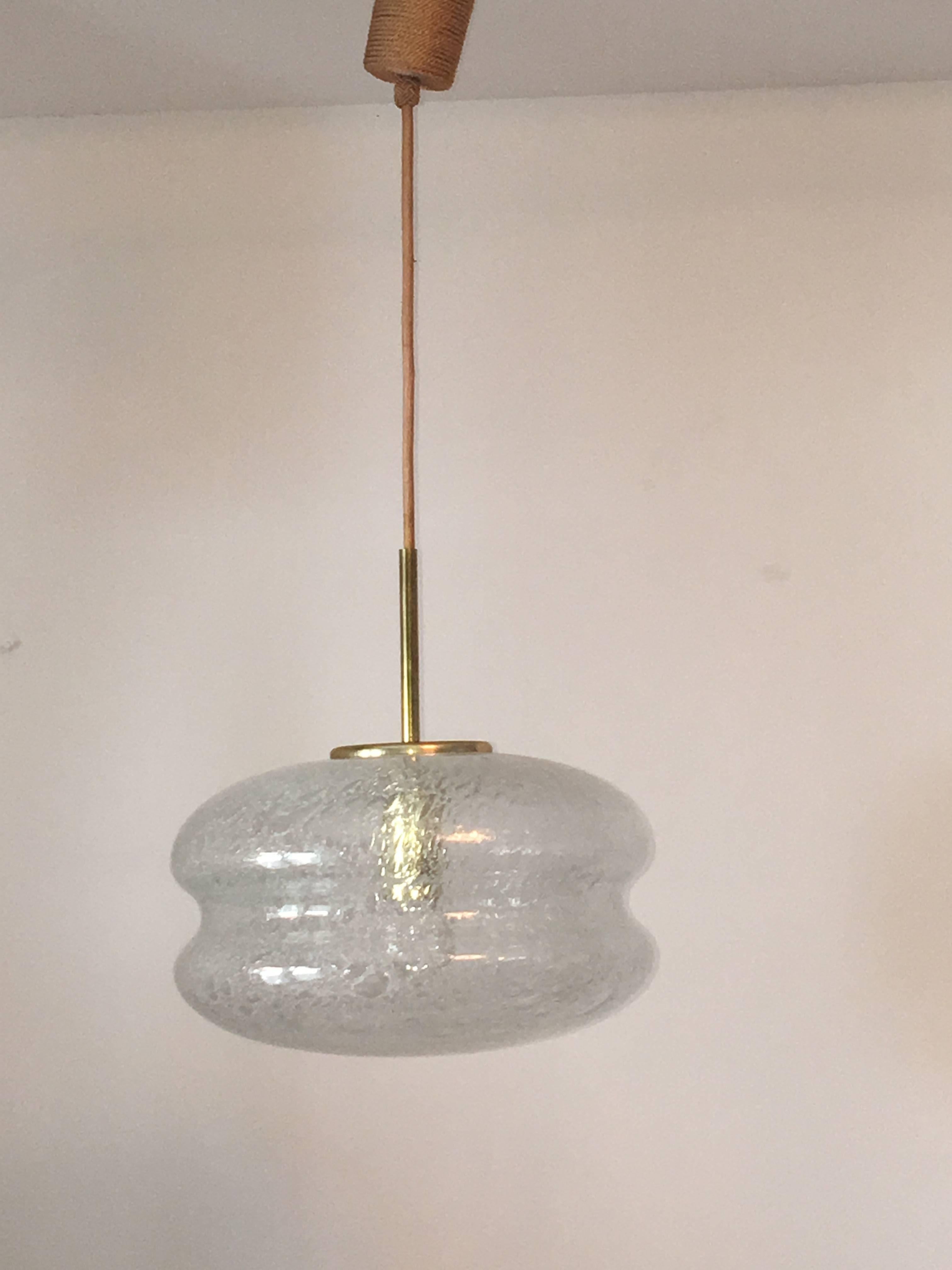 A air bubble glass pendant made in the 1960s by Doria, with cord coiling cable. The fixture requires one European E27 Edison bulbs, the bulb up to 150 watts.