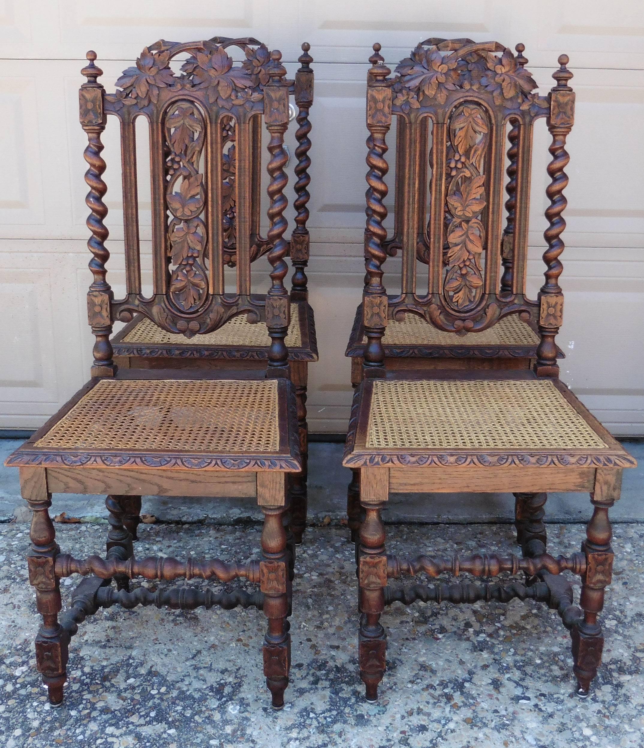 Set of four carved oak Renaissance style chairs with grapes motif , with canework (one chair had his canework damaged).
 