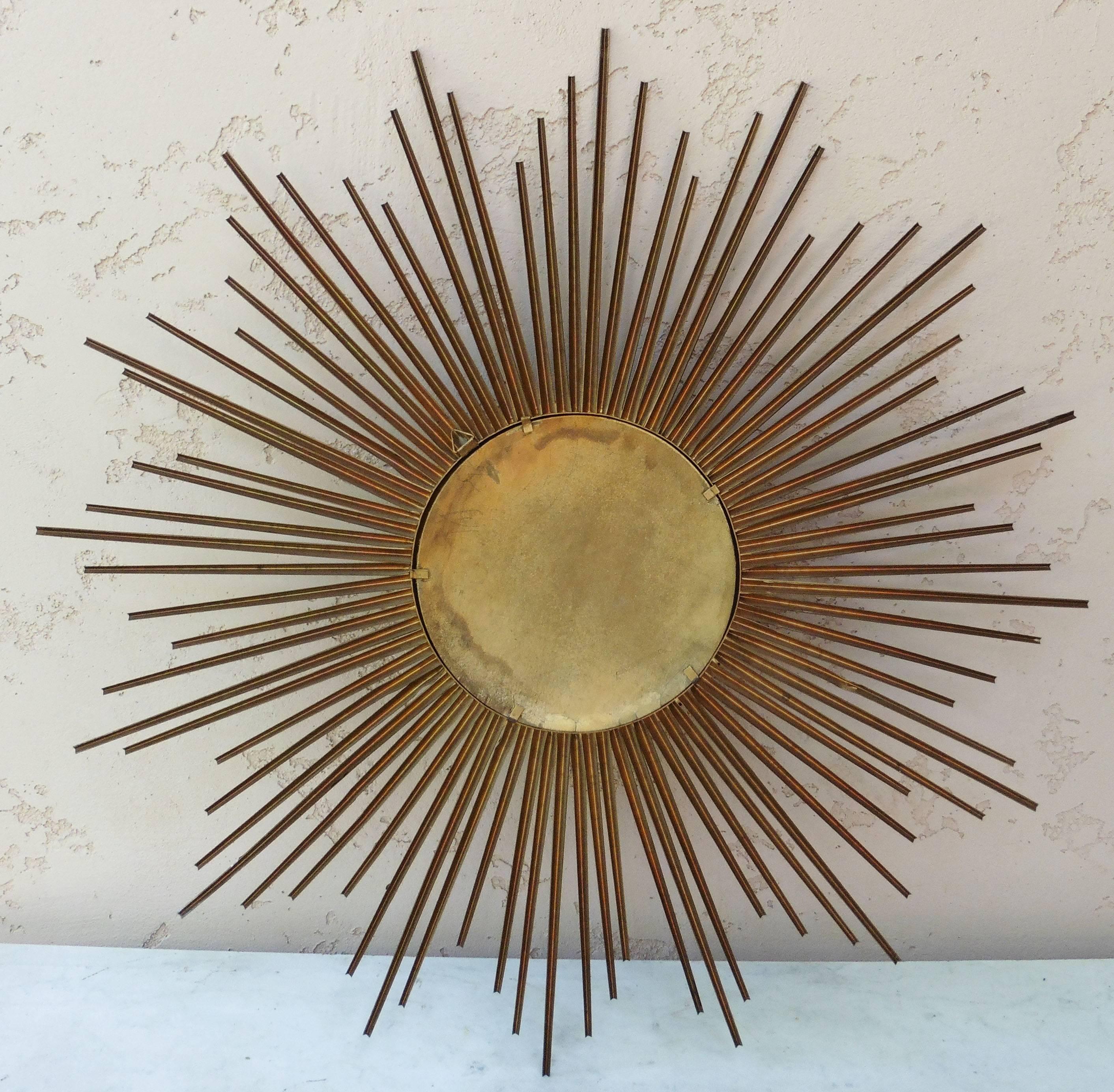 Large sunburst metal mirror signed Chaty Vallauris.
Measures: 9.5 diameter of the convex mirror.