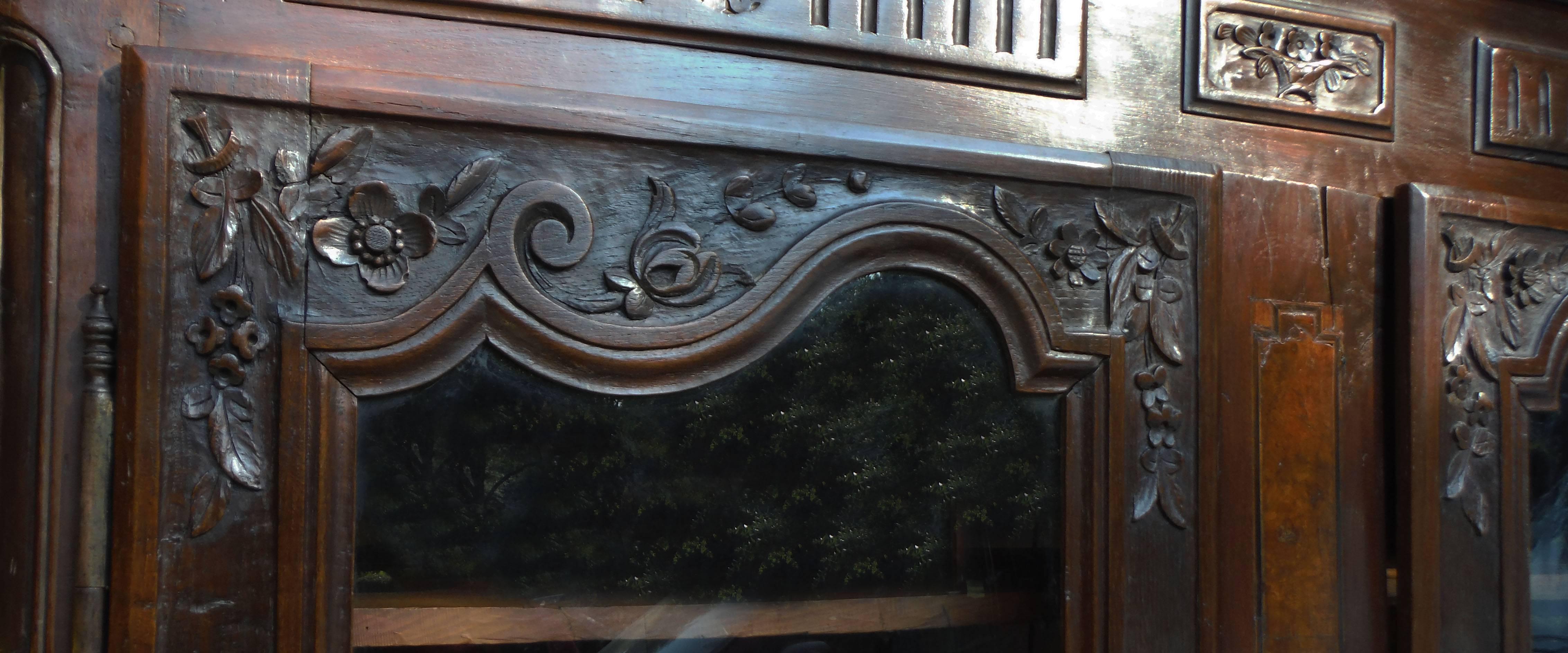 French Provincial wood carved armoire circa 1850, decorated with flowers.