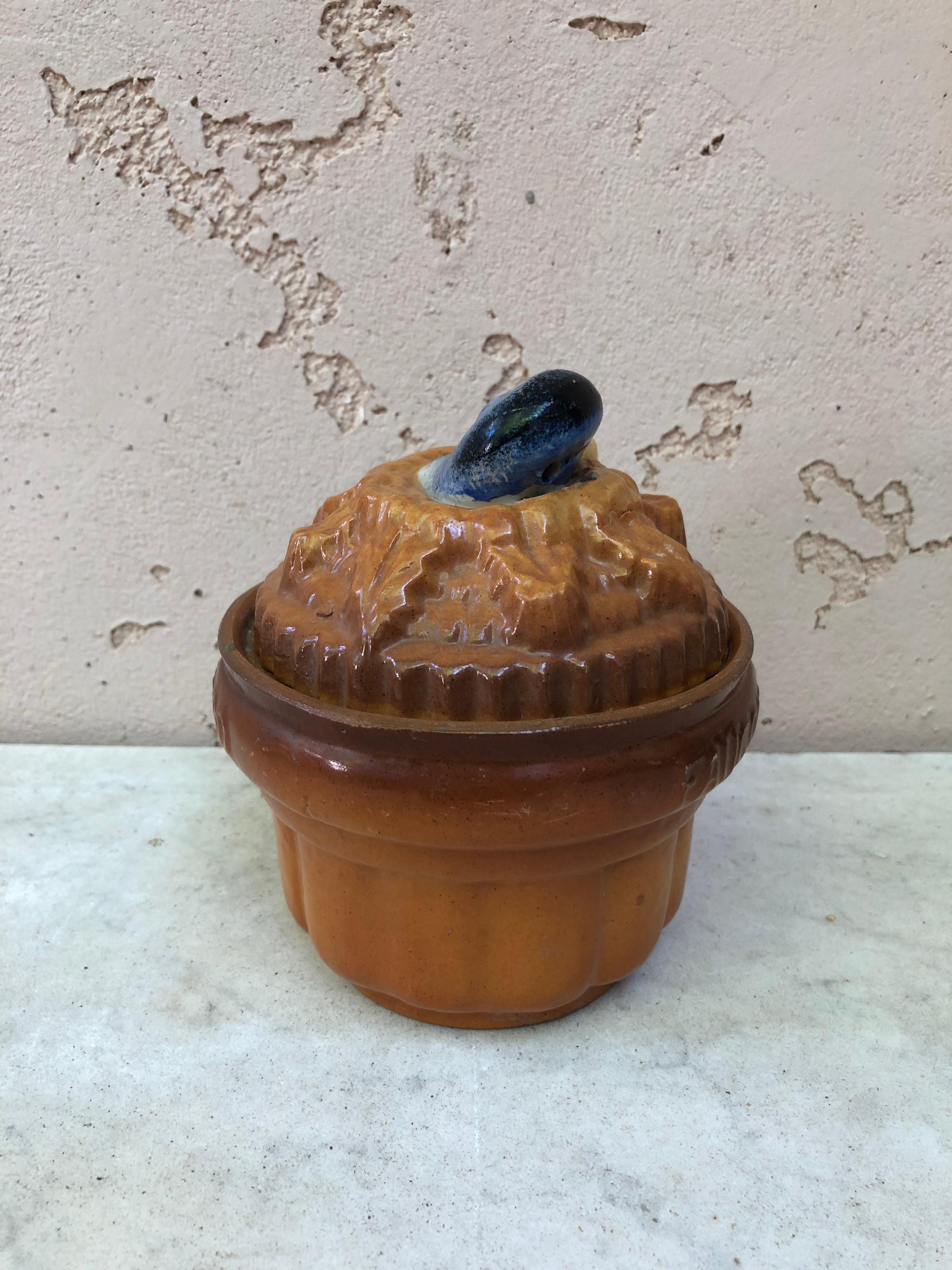 Pate duck tureen signed Georges Dreyfus for Faucon-Rouen circa 1900 in a trompe l'oeil form of pie with duck head handle.