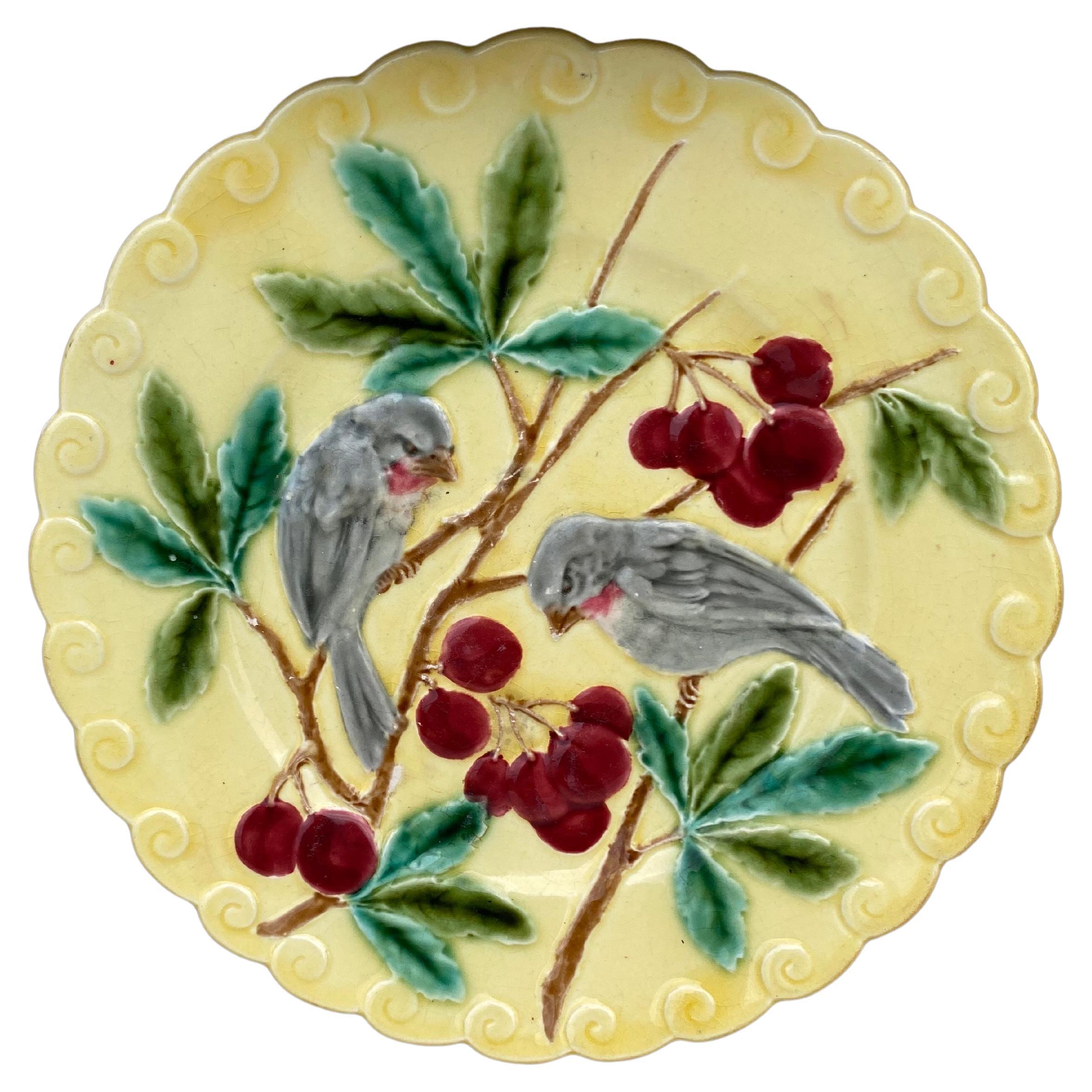 French Majolica bird with Cherries plate signed Sarreguemines circa 1880 on a rare yellow background usually aqua color.