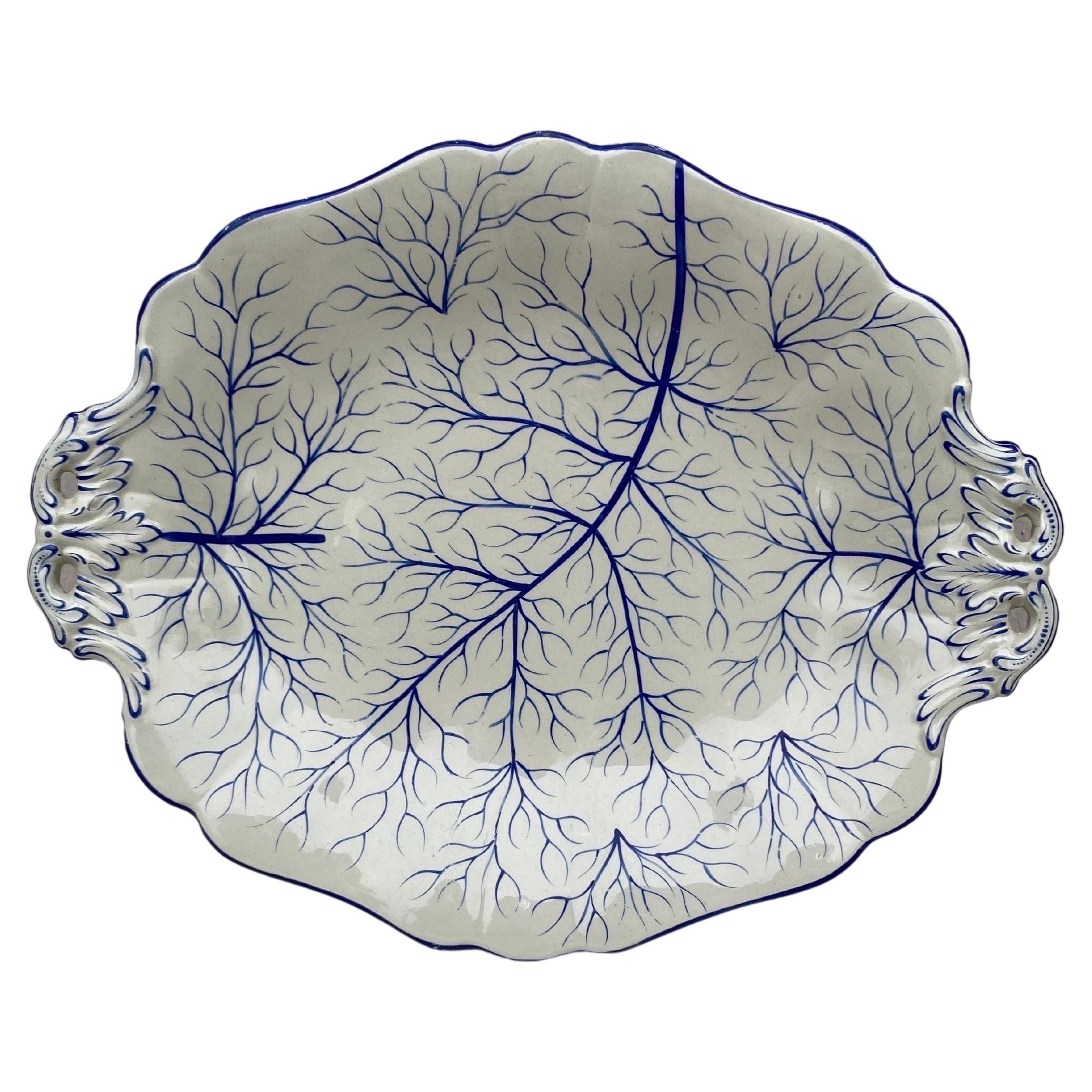 English Majolica oval blue and white platter, circa 1890.
Painted branches.
Measures: Length 11.7 inches on 9, height 1.5 inches.
Chip on the back.