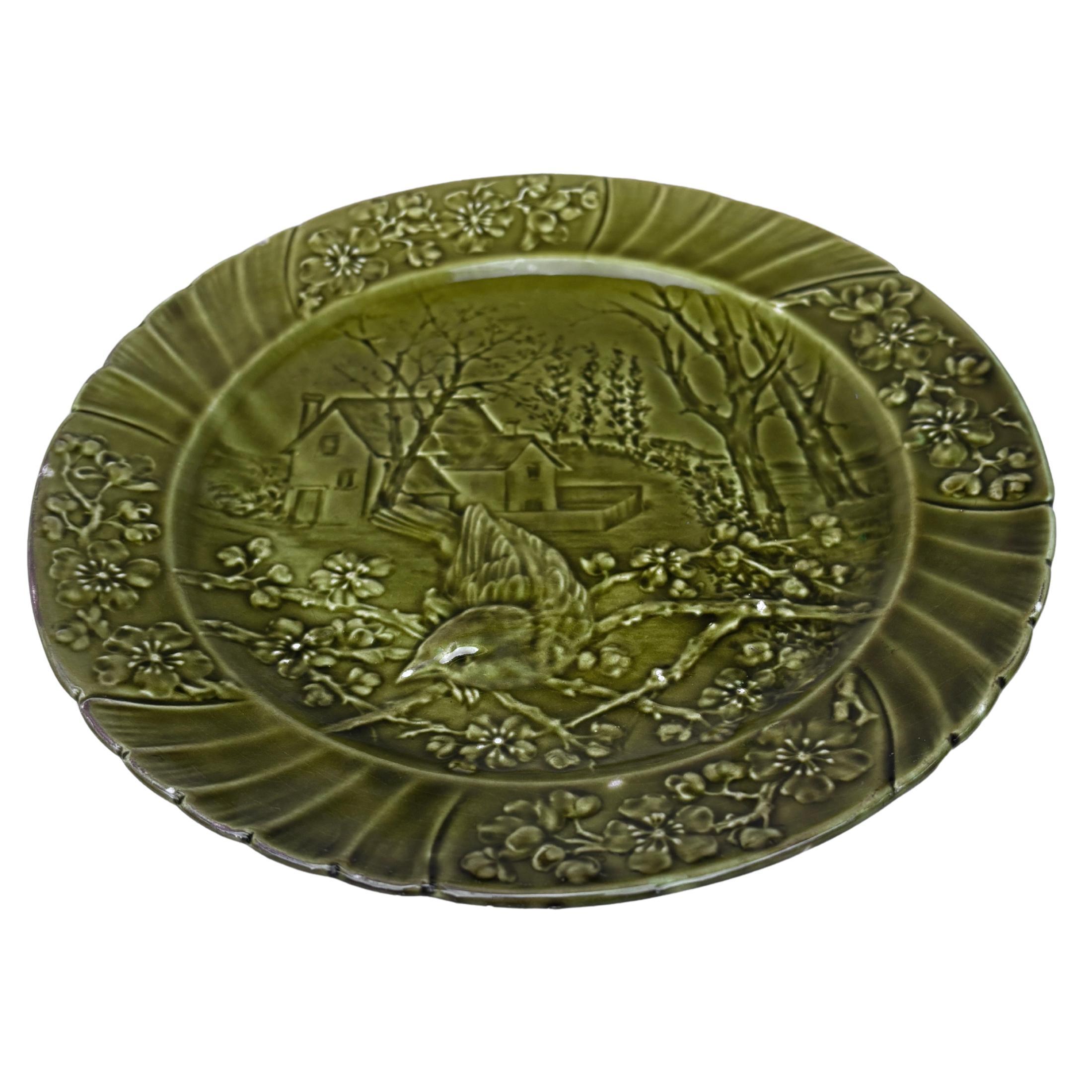 Plato de pájaro de mayólica verde del siglo XIX firmado Sarreguemines.
Este plato representa la primavera con flores de cereza.