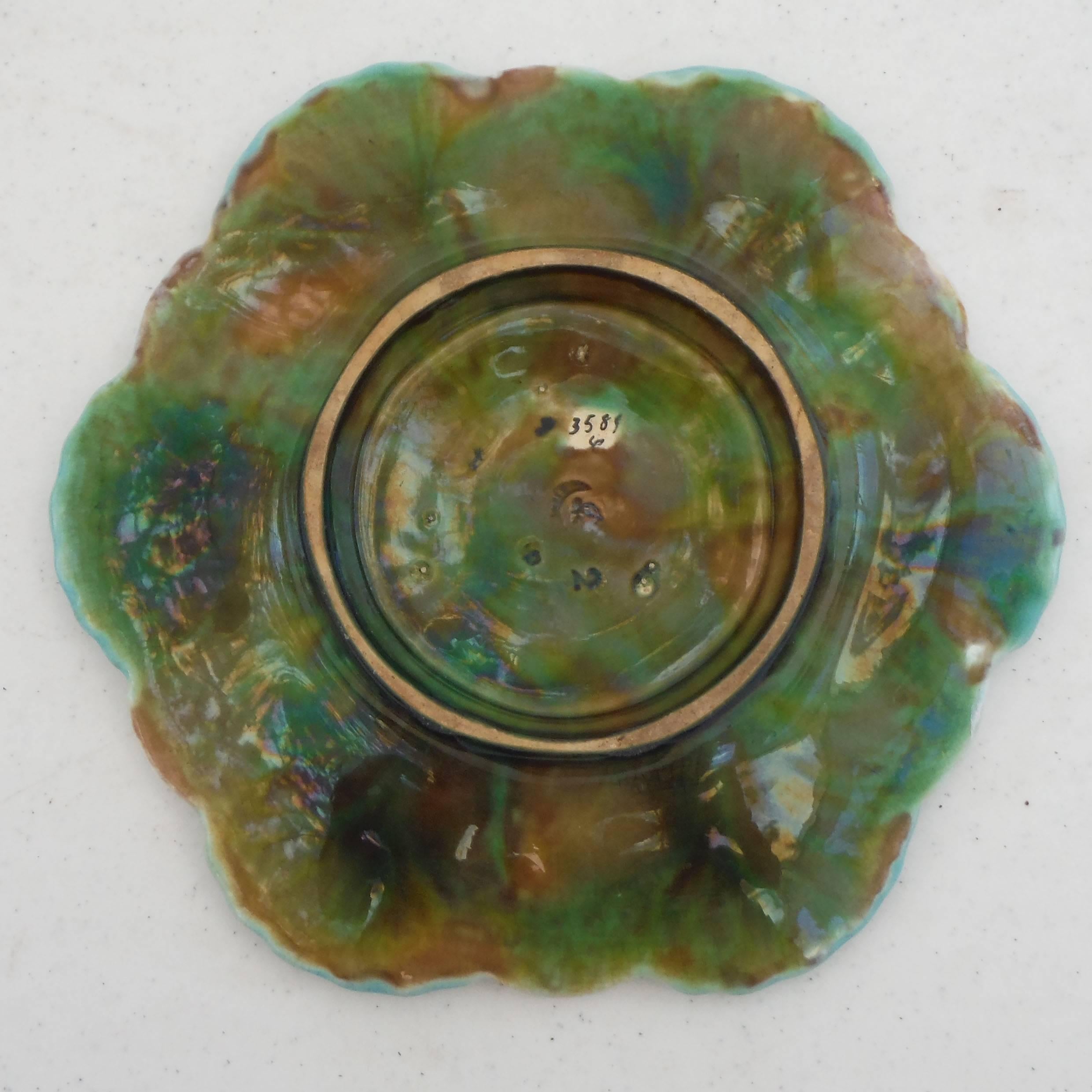 Antique English turquoise Majolica oyster plate signed George Jones, circa 1878.
This six well oyster plate is a fine example of the work of George Jones, with a beautiful glaze and aqua color. The details of the plate with different kinds of