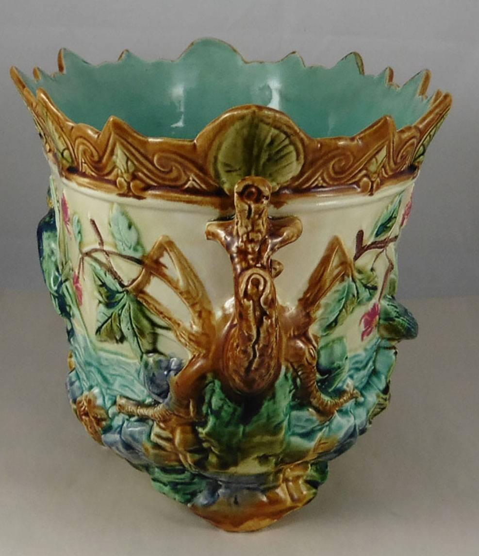 Antique large Majolica jardiniere showing two kingfishers on a pond with aquatics plants and flowers, handles with branches circa 1880 signed Onnaing.