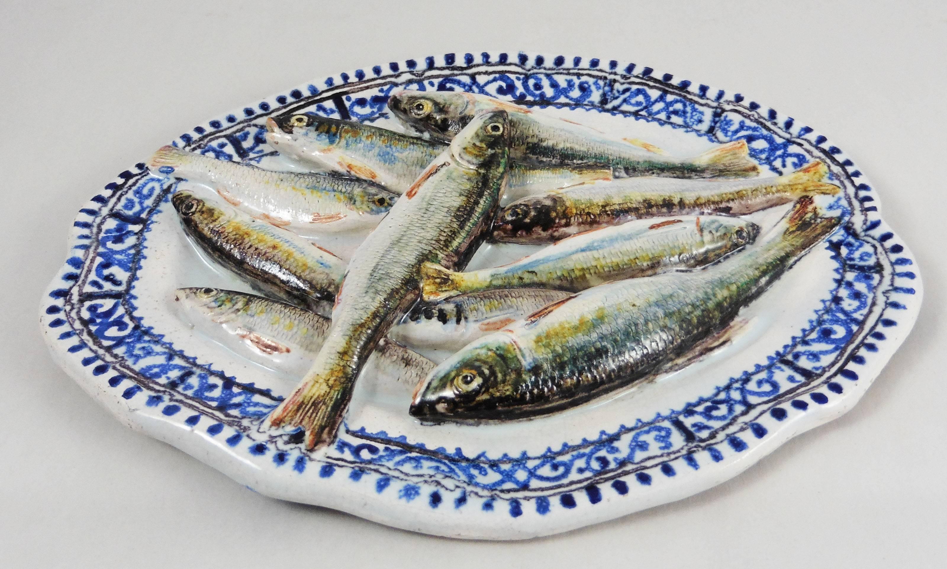 This is a luminous trompe l'oeil composition of Leon Brard with sardines on a rustic blue and white platter in the Rouen style.
In 1859 fascinated by the work of Avisseau Leon Brard set up in Tours to work in the Palissy style. Fist painter but