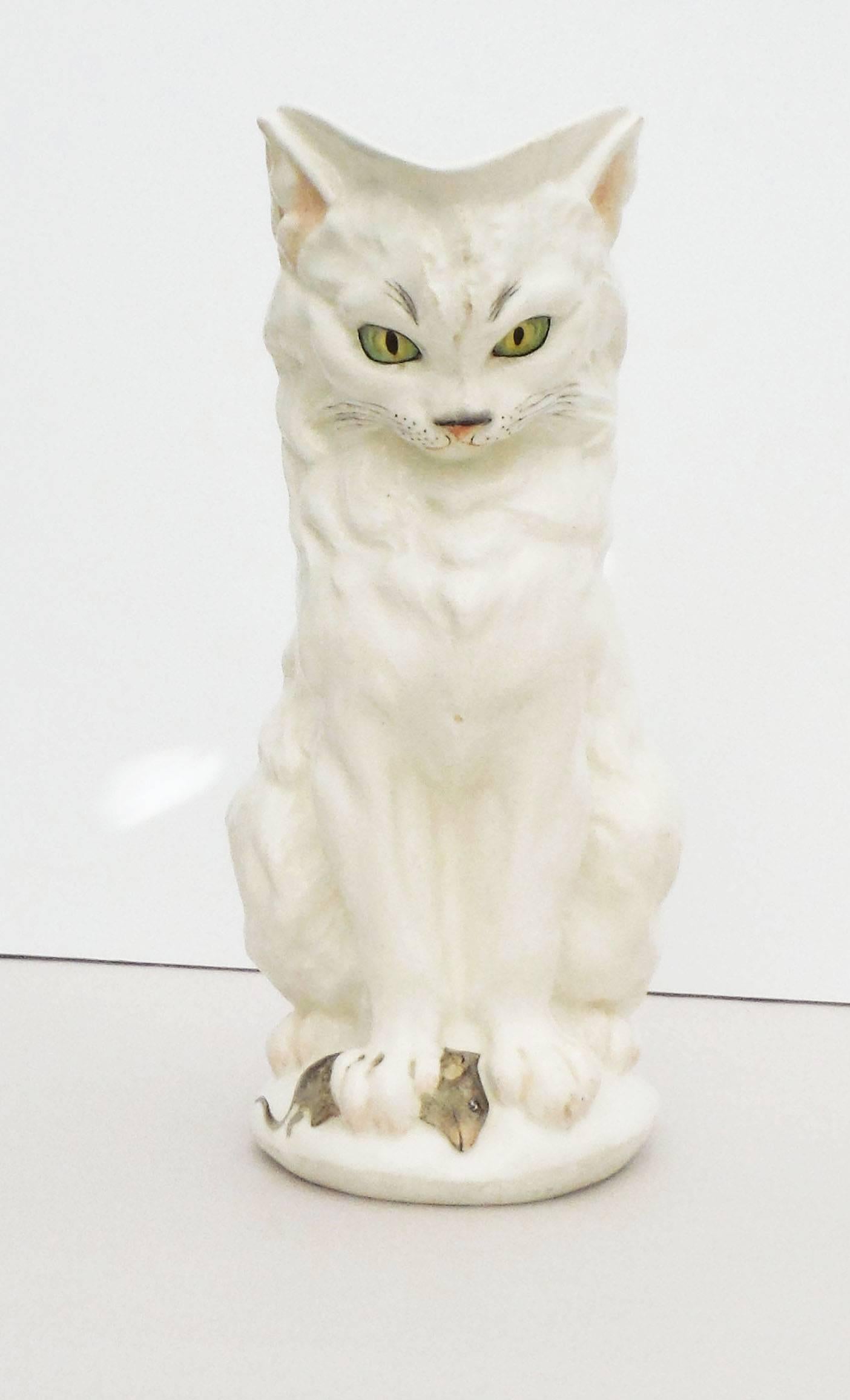 A very rare white Majolica cat pitcher trapping a mouse under its right paw its tail forming the handle signed Mintons, dated October 1874. 
The shape number is 1924.
Probably designed by Paul Comolera. Comolera is best known for his large models