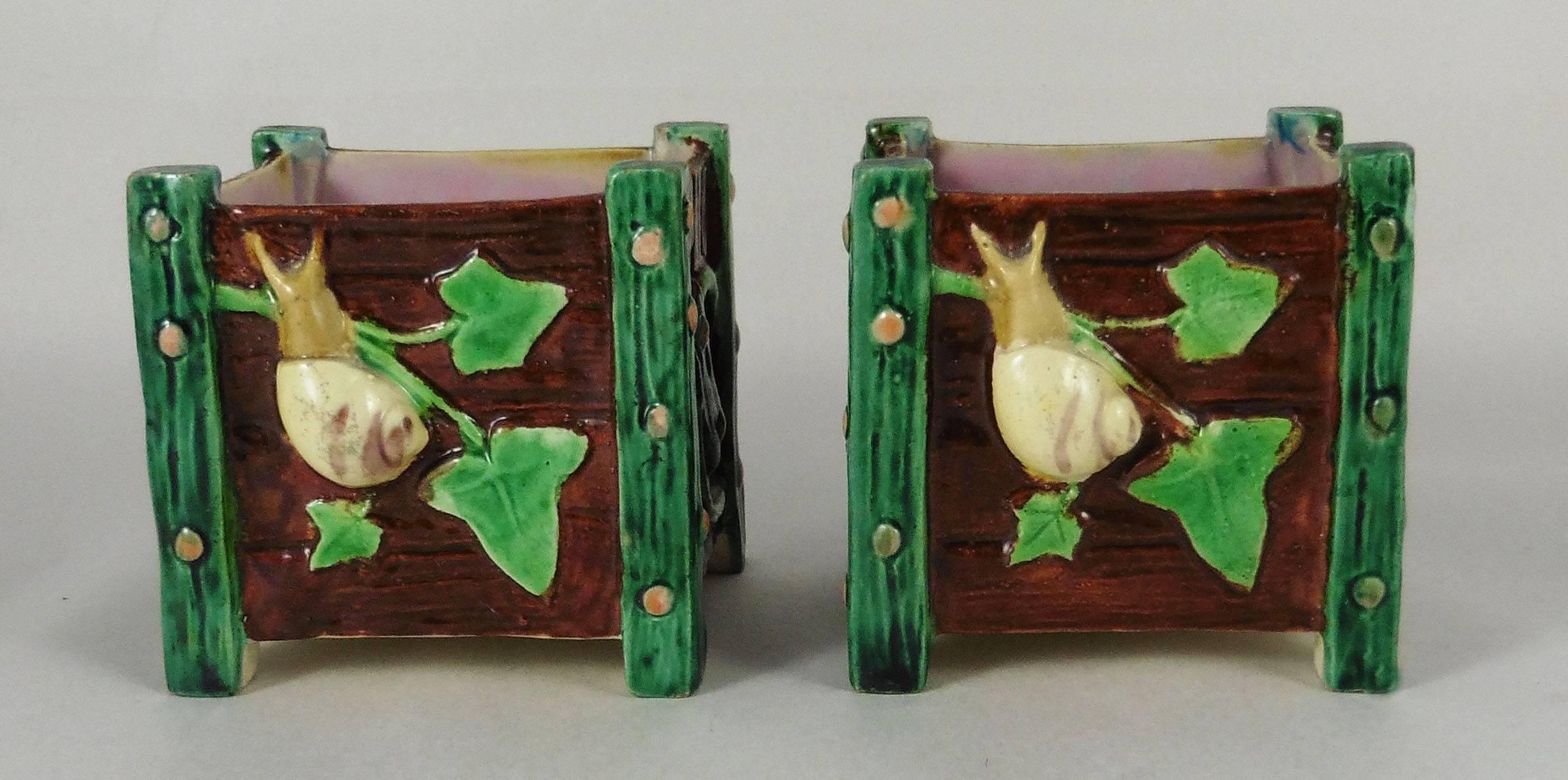 Pair of Victorian Majolica jardinieres in a shape of wooden fence boxes with ivy, a snail and a butterfly signed Royal Worcester, circa 1880.