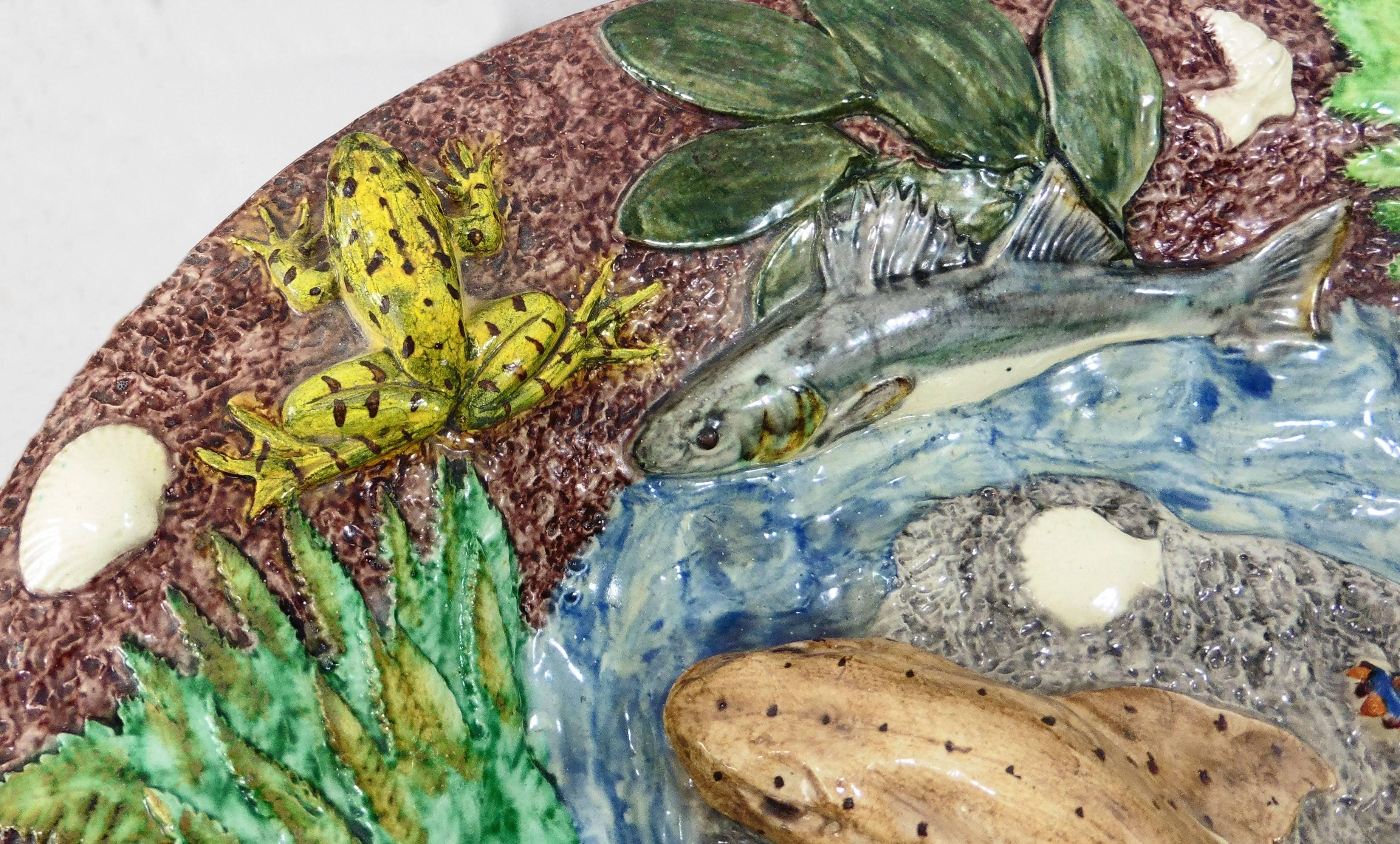 19th century large Palissy wall platter a large catshark on the center surrounded by four fishs, two frogs, two crawfishs, two lizards, shells and different greens plants on a brown background signed Thomas Sergent.
Thomas Victor Sergent was an
