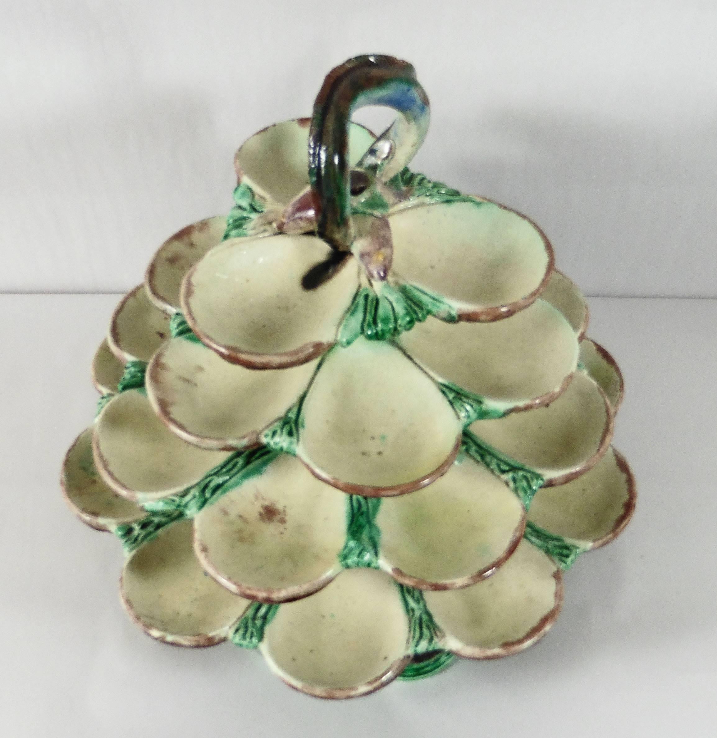 19th century rare Majolica Palissy oyster server with four graduated rows of oysters
holders, finial modeled as two fishs and an eel that form the handle, on stand.
Attributed to Thomas Sergent.
The School of Paris is composed by makers as Victor