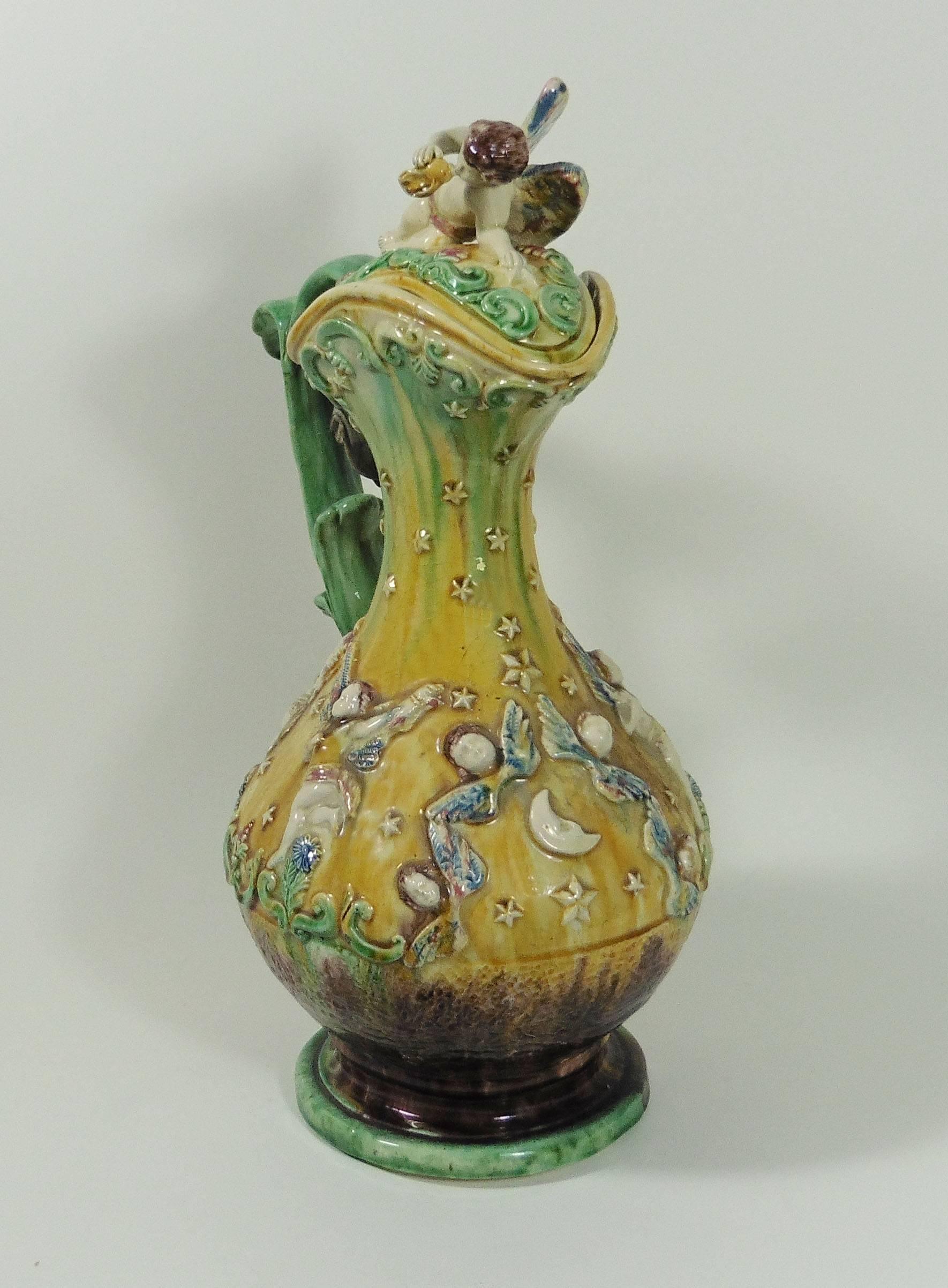 Large 19th Portuguese Palissy lidded ewer with angels, stars, moon, the lid is a large angel with a conch signed Manuel Mafra Caldas da Rainha.
The handle is an aquatic mythical creature.